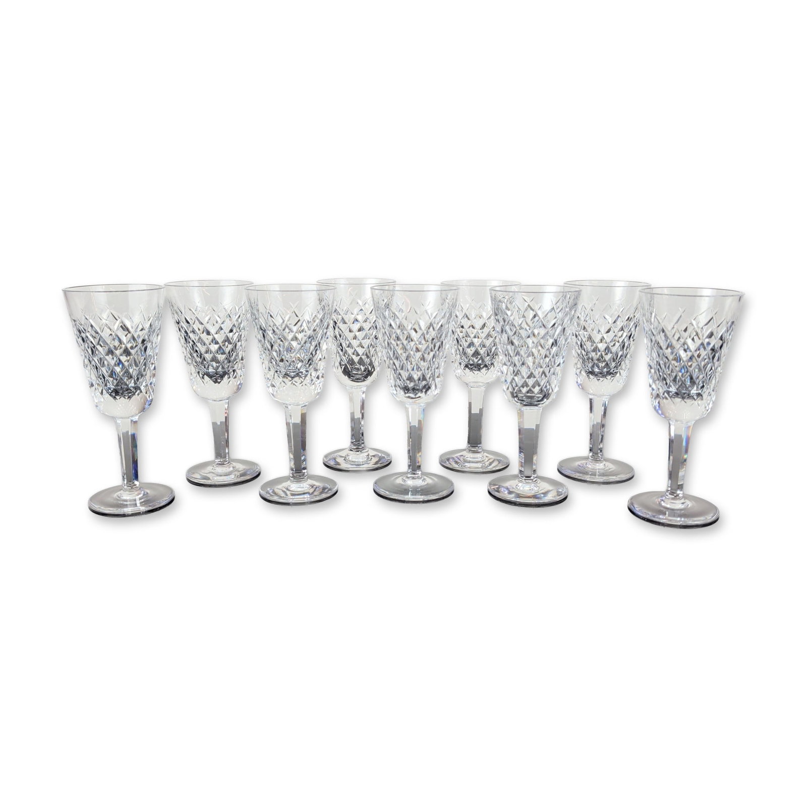 9pc Waterford Alana Crystal Sherry Glasses: Waterford lead crystal stemware in the Alana pattern, comprising nine matching pieces. Each vessel features a bowl decorated with a band of deep crisscross diamond cuts beneath a row of vertical wedge
