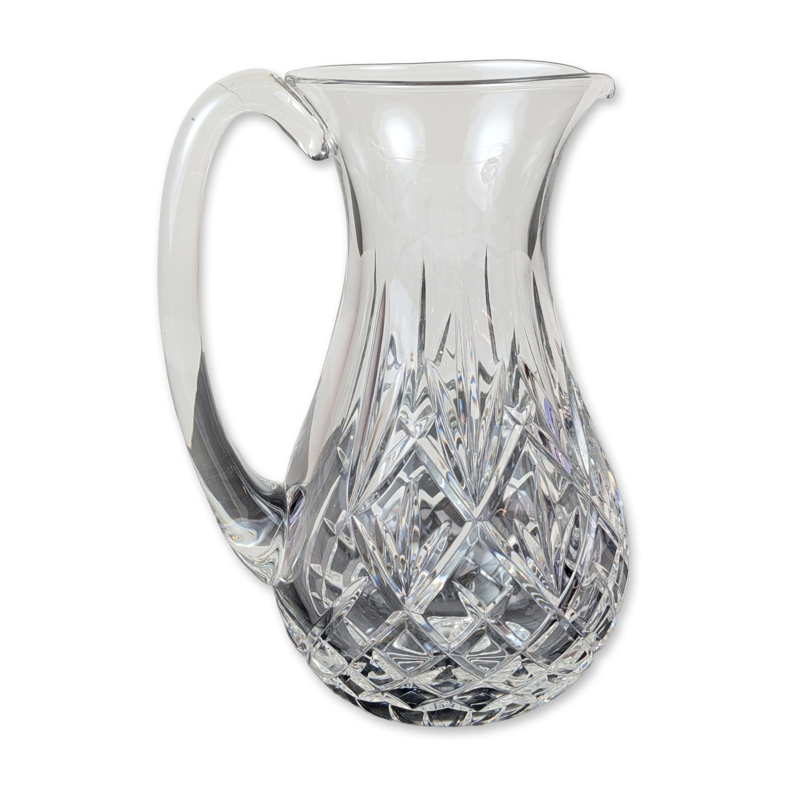 Waterford Crystal Eve Pattern Pitcher: Waterford lead crystal pitcher in the Eve pattern, featuring a flared rim with a pinched pouring spout and an applied clear glass handle. The body is decorated with a series of vertical wedge cuts on 