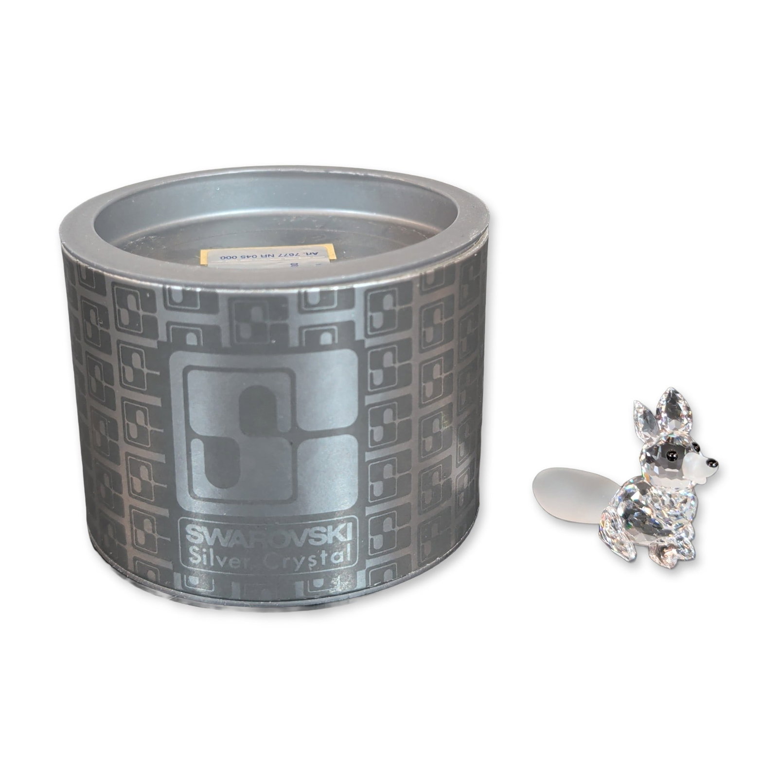 Swarovski Silver Crystal Figurine, Mini Sitting Fox: Figurine in faceted and frosted lead crystal, featuring a clear faceted body, frosted snout and tail, and black bead accents for the eyes and nose. Identification label on original cylindrical retail 