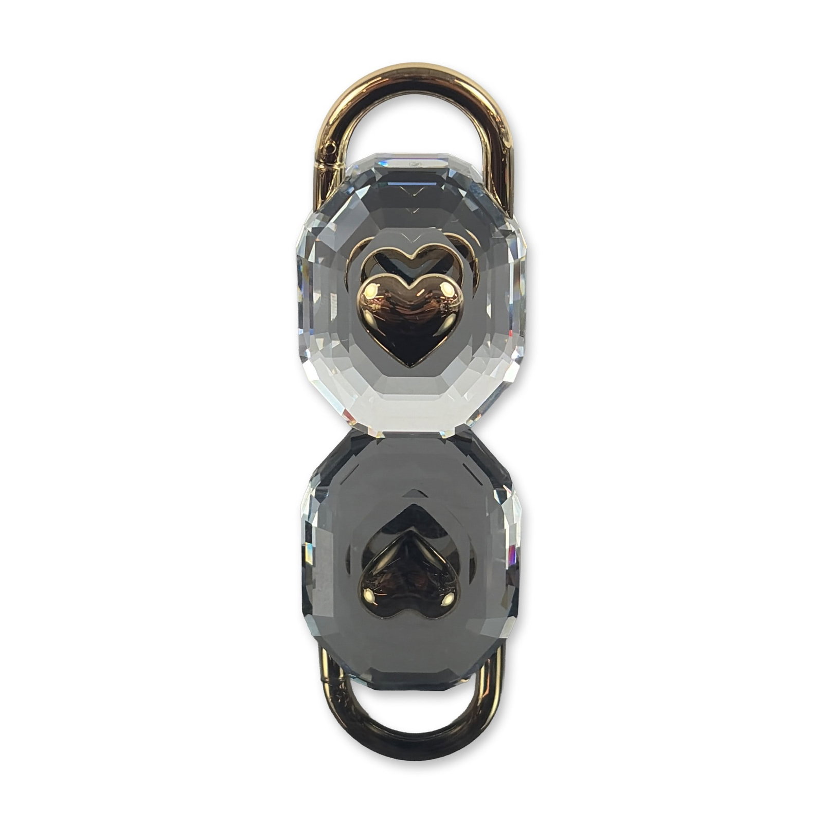 Swarovski Symbolica Crystal and Gold Tone Padlock Figurine: Swarovski crystal padlock figurine from the Symbolica collection, model number. The piece features a clear multi-faceted crystal body in an octagonal emerald-cut style with a polished gold-tone heart