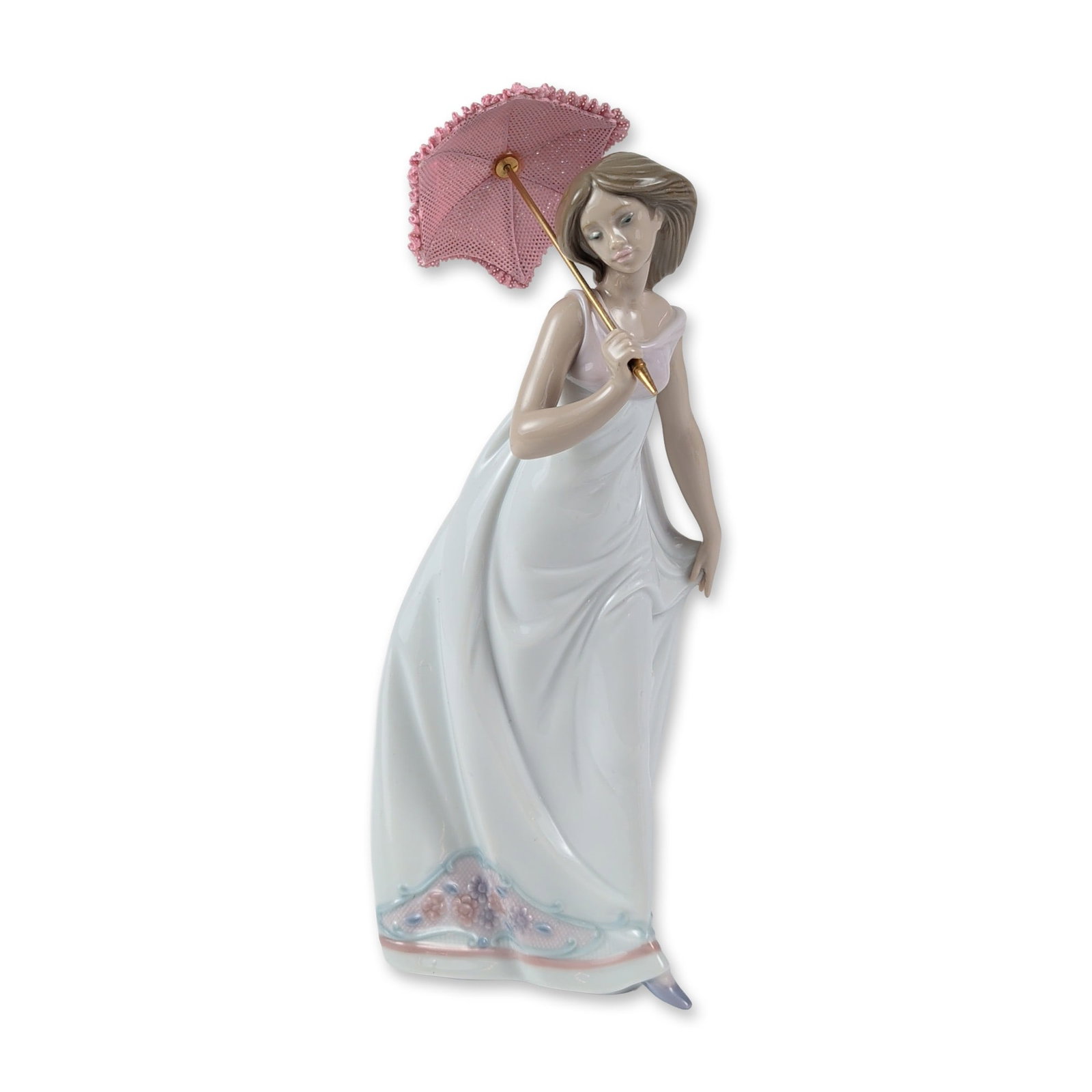 Lladro Porcelain Figurine, Afternoon Promenade 1007636: Spanish Lladro glazed porcelain figurine, titled Afternoon Promenade, model 1007636, depicting a young woman in a sleeveless white gown holding a pink parasol with lace-textured details. The hem of th