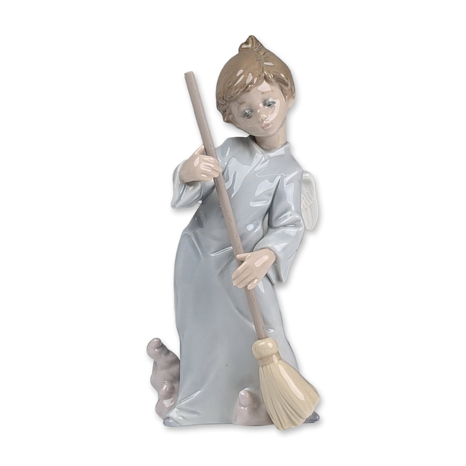 Lladro Porcelain Figurine, Sweep Away the Clouds 1005726: Depicting a young angel or cherub in a reclining position sweeping with a broom. The figure is dressed in a pale blue-gray gown, and the broom features a textured handle with yellow bristles. The unde