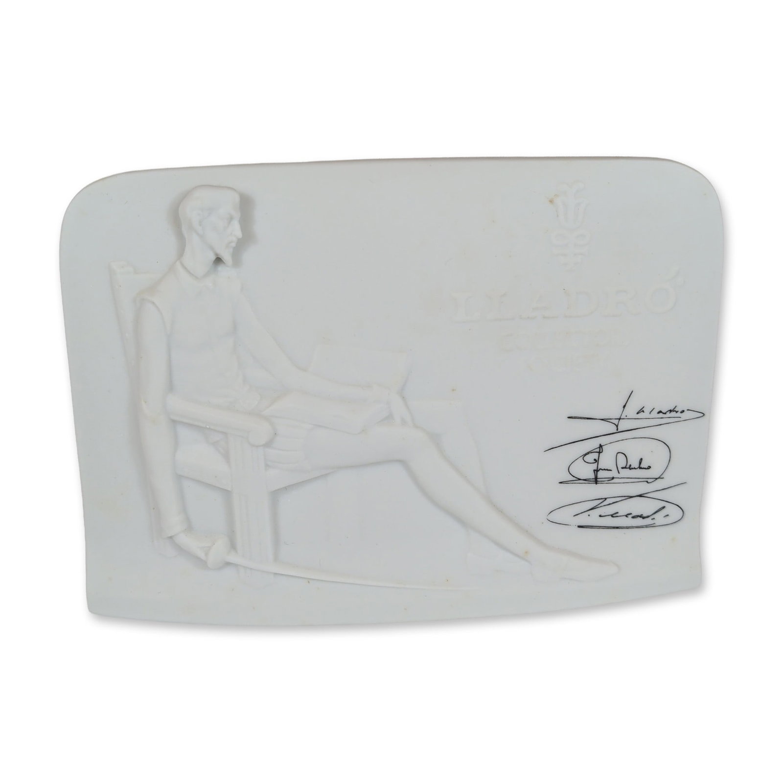 Lladro Porcelain Collector's Society Don Quixote Plaque: Lladro Collector's Society display plaque in white matte bisque porcelain, featuring a bas-relief depiction of Don Quixote seated with a book. The reverse side features a molded shell motif. The front