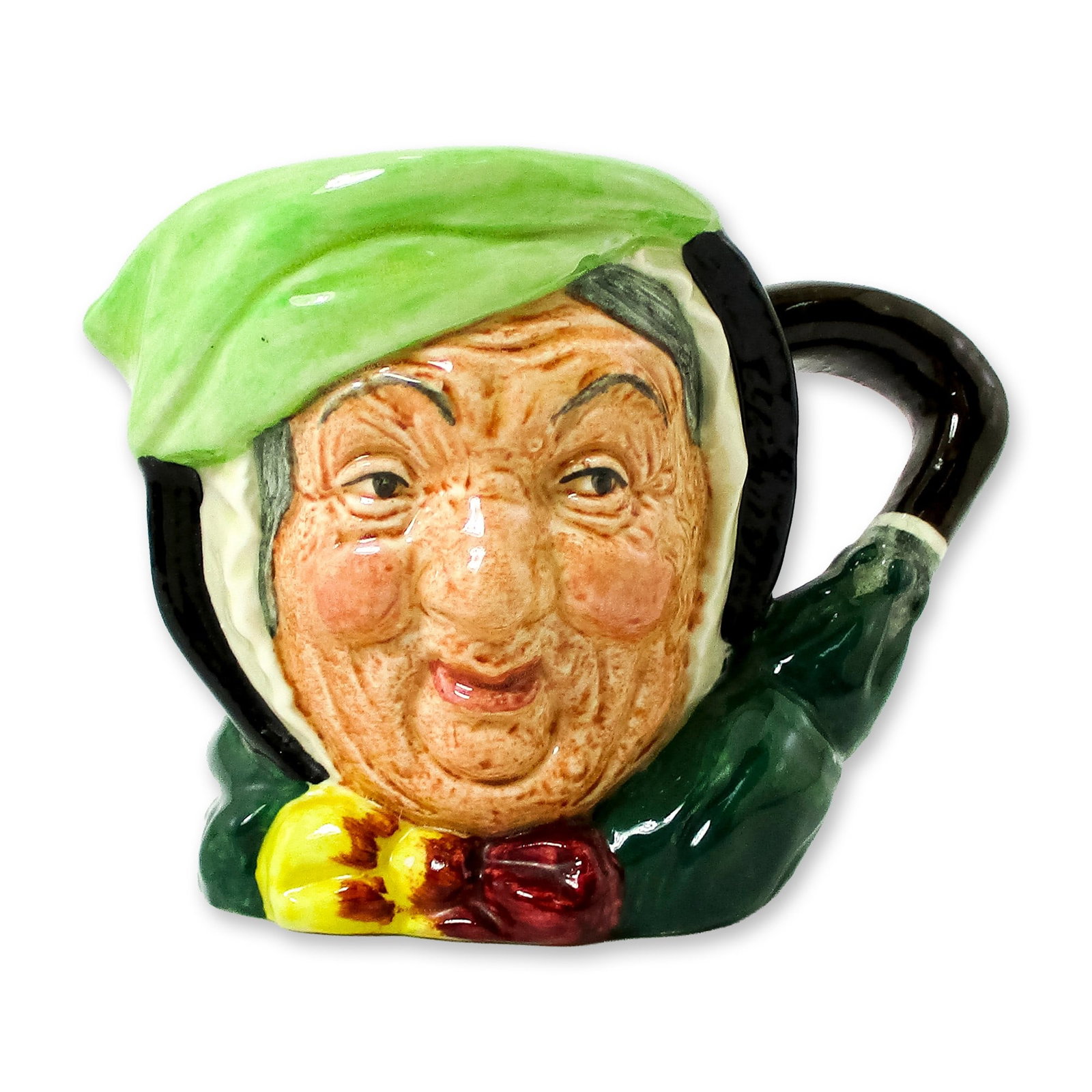Sairey Gamp D5528 - Small - Royal Doulton Character Jug: Black hair; light green band; dark green coat; yellow and burgundy bow; green umbrella with brown handle. Royal Doulton backstamp. Artist: Leslie Harradine and Harry Fenton Dimensions: 3.25"H Date or 
