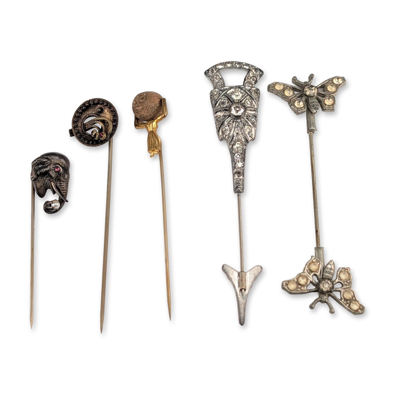 5pc Collection of Victorian and Art Deco Stick Pins: Collection of five antique and vintage stick pins in various figural and geometric designs. The group includes a patinated metal elephant head pin featuring round pink sapphires for the eyes and a see