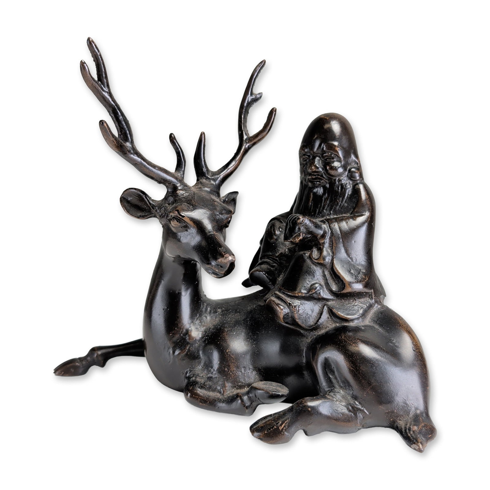 Chinese Style Patinated Cast Iron Shoulao on Deer Sculpture: Chinese style figural sculpture in patinated cast iron, featuring Shoulao, the Star God of Longevity, seated on a recumbent deer. The deity is depicted with a characteristically elongated cranium and 