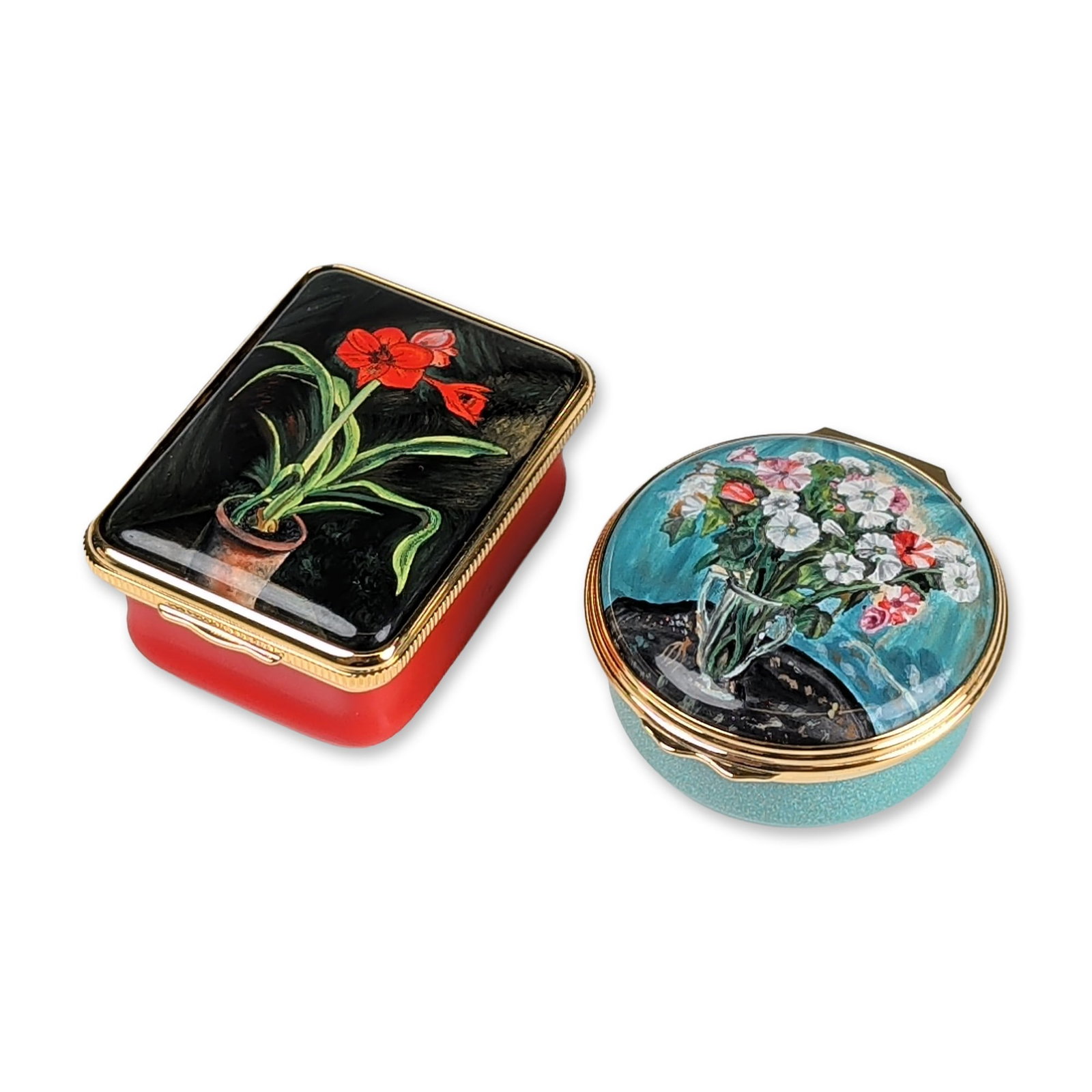 2pc Halcyon Days Winston Churchill Art Enamel Trinket Boxes: Two Halcyon Days enamel on copper trinket boxes featuring hand-painted floral designs based on original artworks by Sir Winston Churchill. The rectangular box features a red base and gilt metal mounts