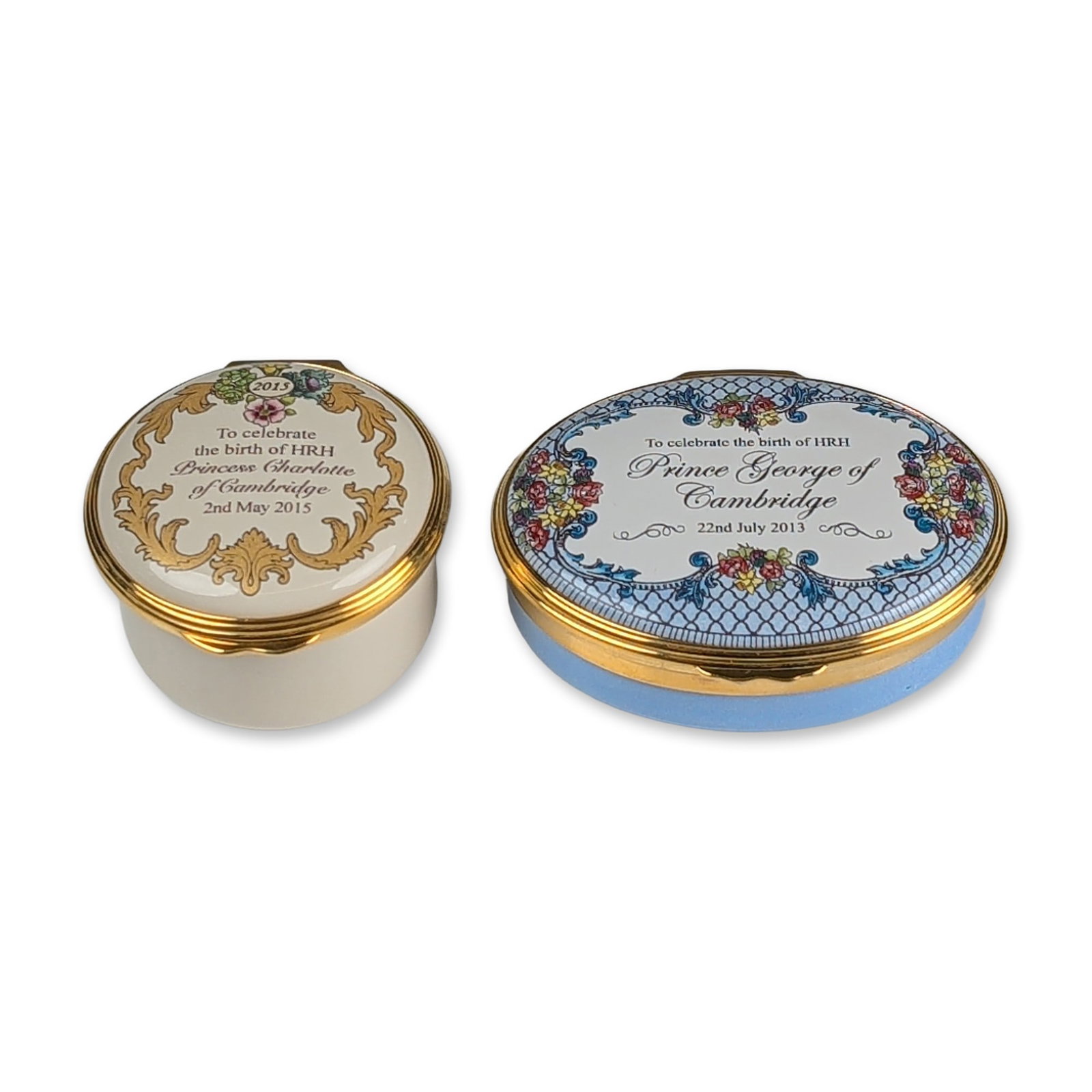2pc Halcyon Days Royal Birth Commemorative Enamel Jewelry Boxes: \Pair of English enamel-on-copper jewelry boxes, produced to celebrate the births of HRH Prince George and HRH Princess Charlotte of Cambridge. The first box, of oval form, features a light blue ename
