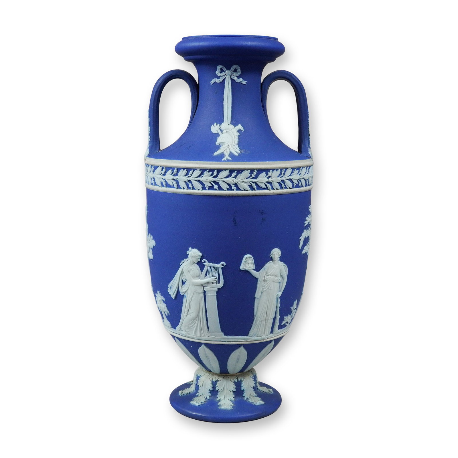 Wedgwood Cobalt Blue Jasperware Apollo and the Muses Amphora Vase: This Wedgwood cobalt blue jasperware amphora-shaped vase features twin loop handles rising from the shoulder to the neck. The body is decorated in white sprigged relief depicting scenes from the Apoll