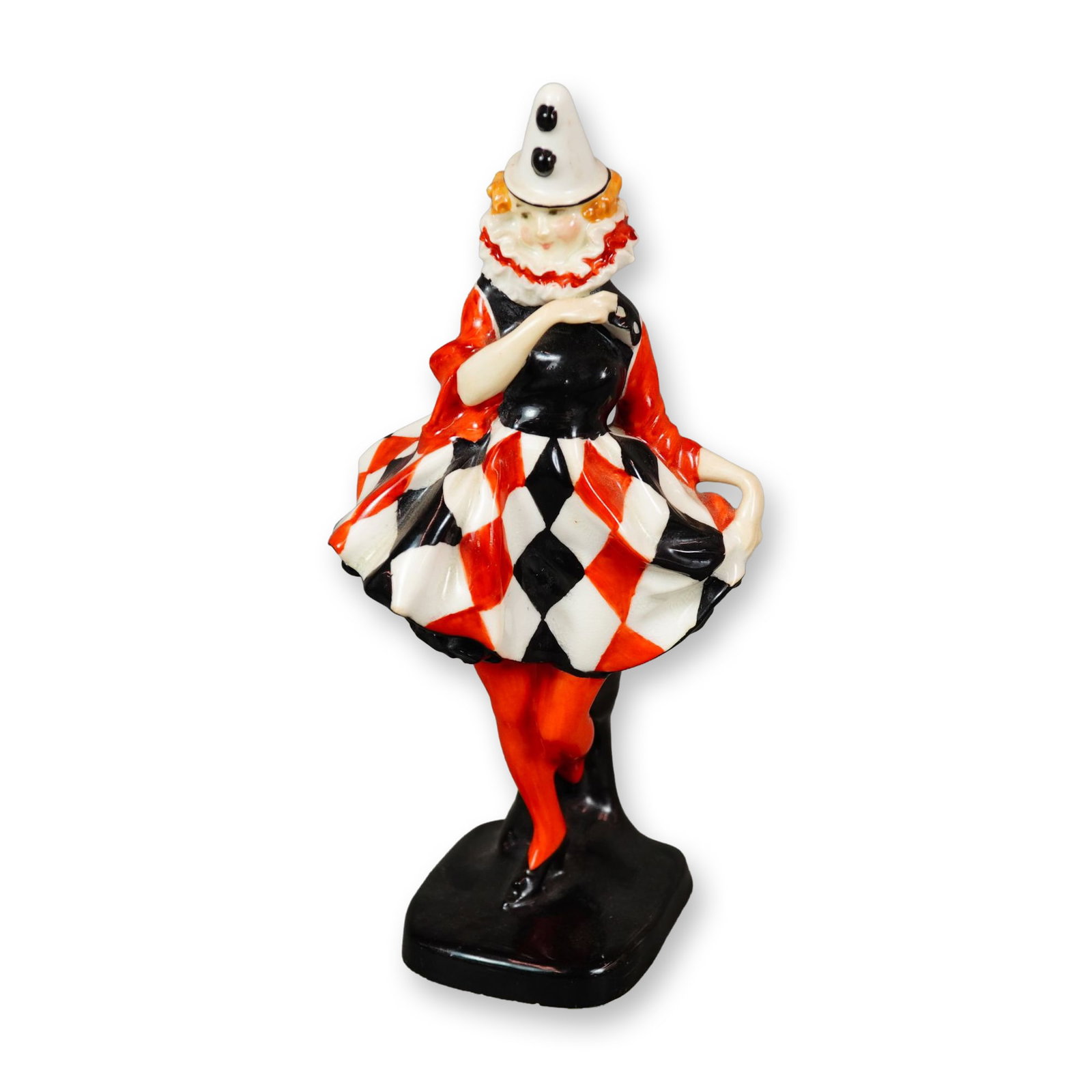 Royal Doulton Figurine, Pierrette HN643: Delightful female clown figurine, elegantly modeled in a harlequin costume featuring vibrant red, black, and white hues. Royal Doulton backstamp. Dimensions: 3.25"L x 3.25"W x 7"H Manufacturer or Bran