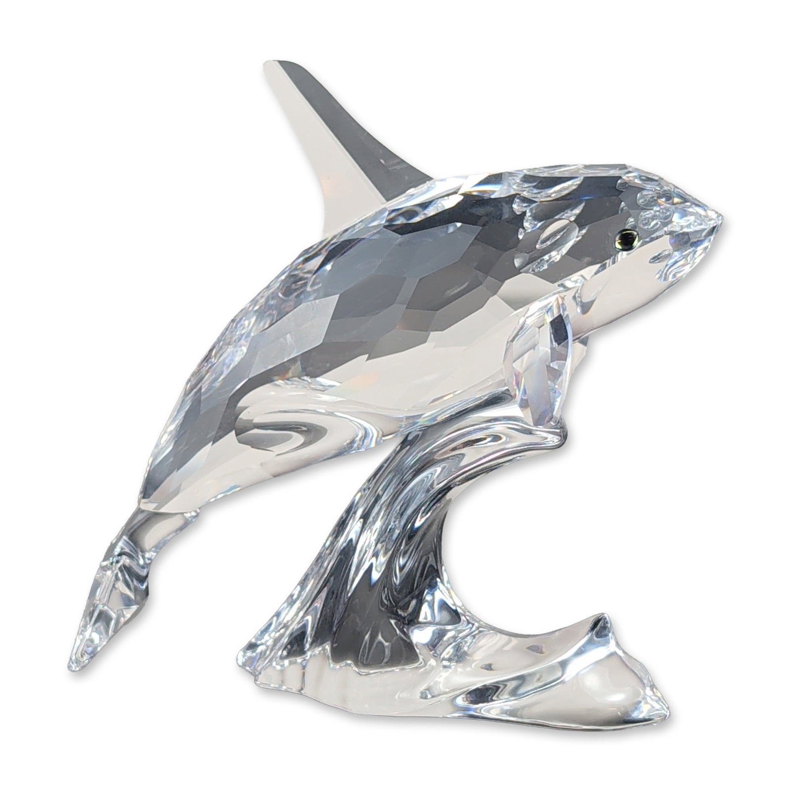 Swarovski Crystal Killer Whale Figurine: Swarovski lead crystal figurine depicting a killer whale leaping over a stylized wave. The whale features a faceted clear crystal body and smooth clear crystal fins with two Moroda crystal eyes. The f