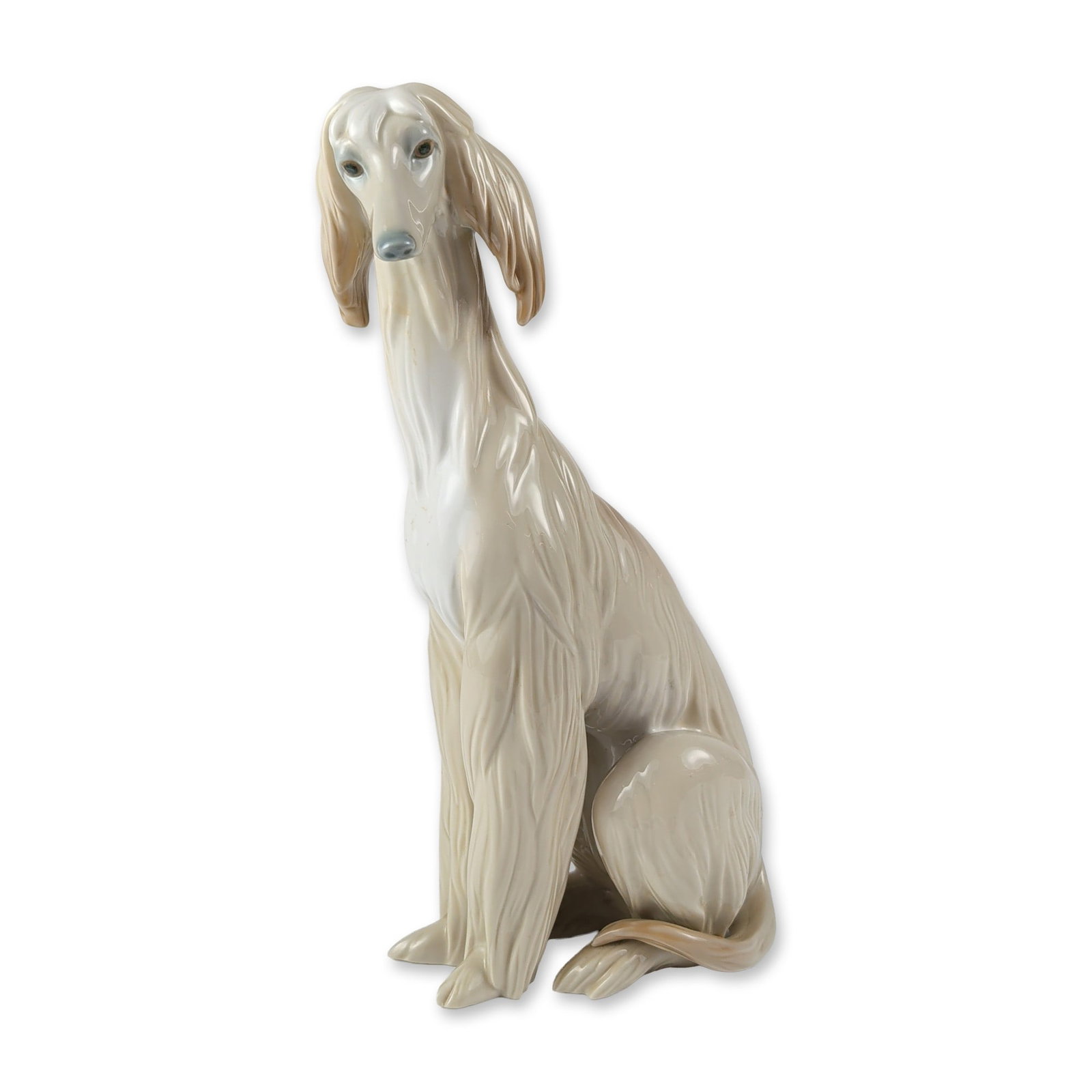 Lladro Porcelain Seated Afghan Hound Figurine 1001069: Lladro glazed porcelain figurine, model number 1001069, titled Afghan Hound and designed by Juan Huerta. The piece depicts a seated dog with a textured coat in a glossy pale beige finish, featuring su