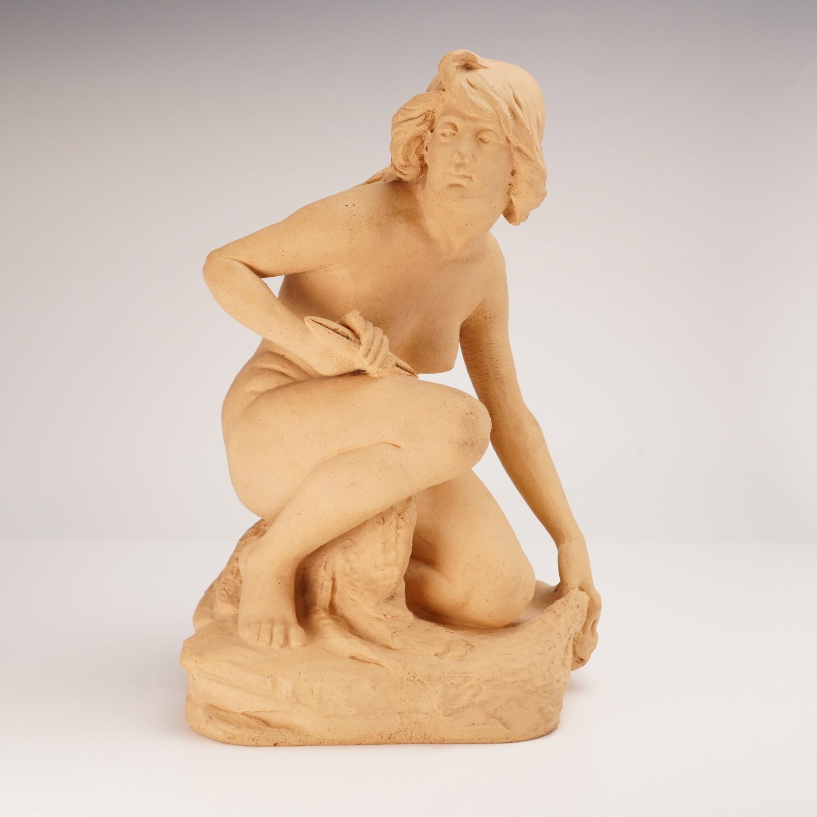 Doulton Lambeth by Herbert Ellis Terracitta Nude Figurine: Doulton Lambeth stoneware figurine depicting a seated nude female with fisherman's netting. Bears the artist's full signature and the Doulton Lambeth backstamp on the side. Dimensions: 7.5"L x 7"W x 1
