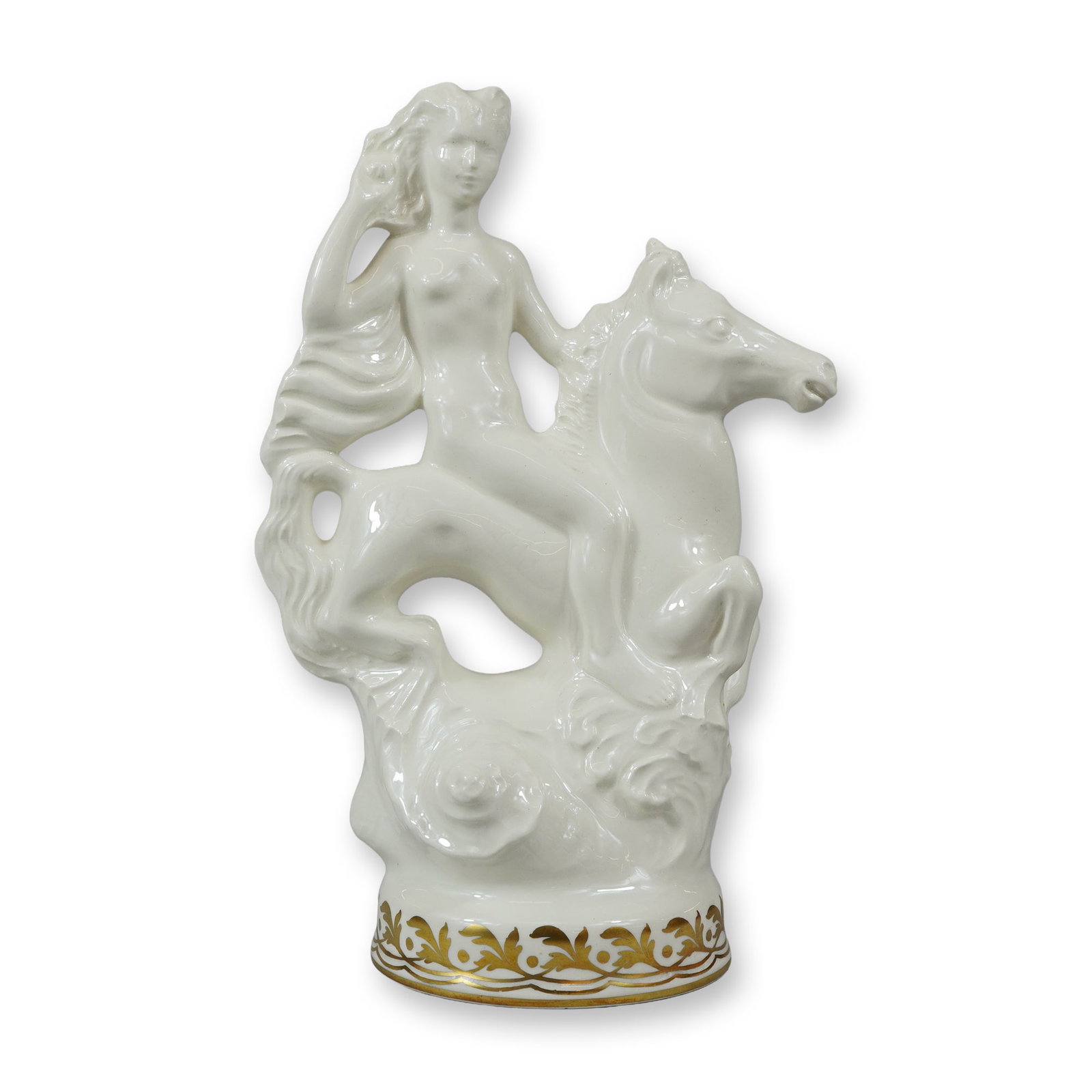 Wedgwood Glazed Creamware and Gilded Nereid on Seahorse Figurine: This glazed creamware figurine, produced by Wedgwood, depicts a nude Nereid, or sea nymph, riding a rearing seahorse. The female figure is modeled with long, flowing hair, with one arm raised toward h