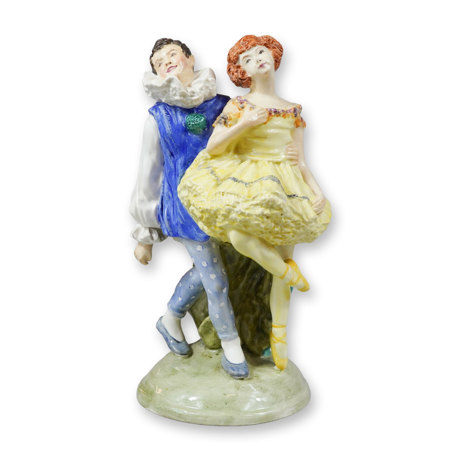 Wedgwood Porcelain Figurine of Pierrot and Ballerina by Kathleen Goodwin: This glazed porcelain figurine depicts a male and female pair in a theatrical dance pose. The male figure is dressed in Pierrot attire, featuring a large white ruffled collar, a blue tunic over white 