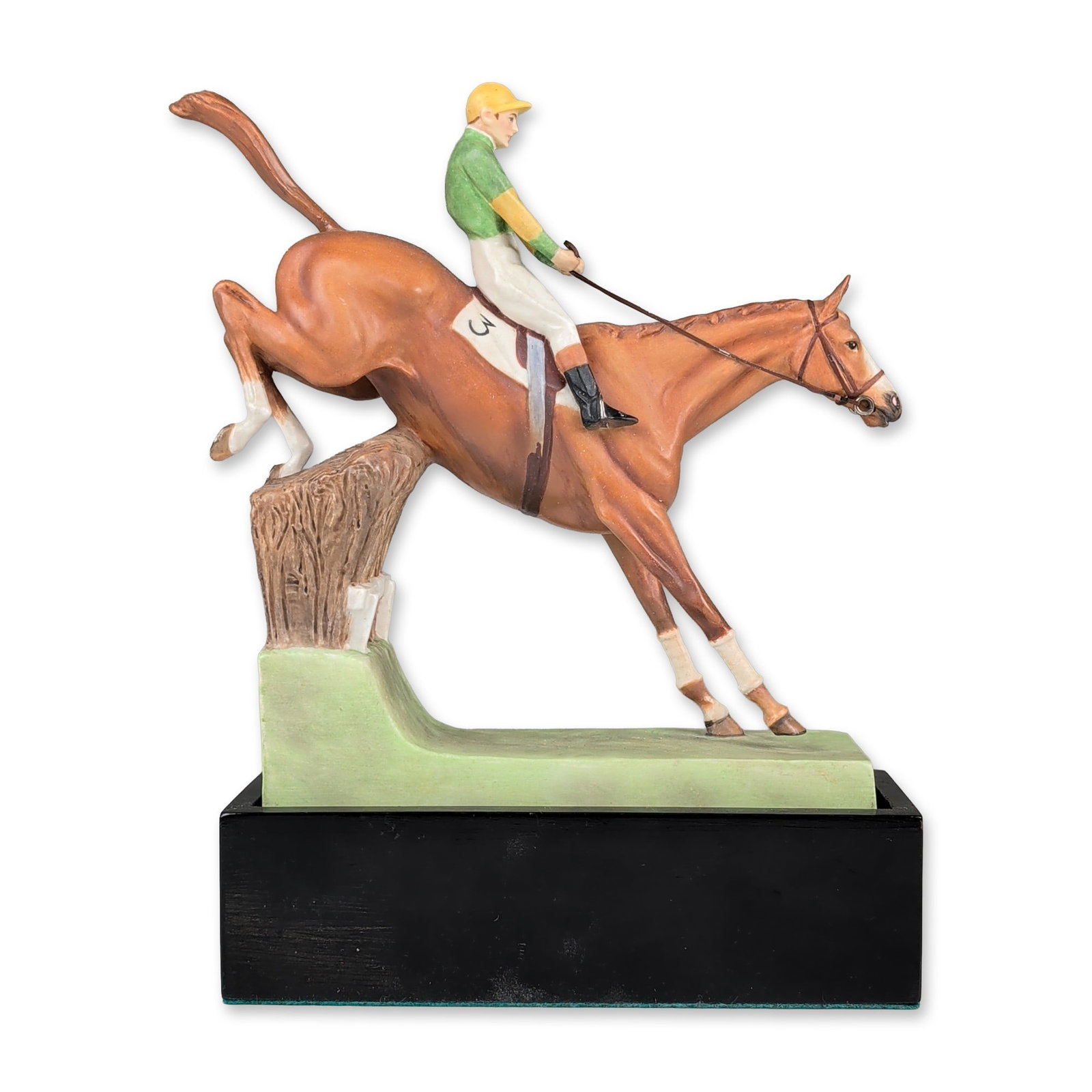 Royal Worcester by Doris Lindner Bone China Figurine with Base, Over the Sticks 3116: Hand-painted porcelain equestrian figurine titled Over the Sticks, modeled by Doris Lindner. The figure depicts a chestnut horse and jockey in mid-leap over a brush-style fence. The jockey is wearing 