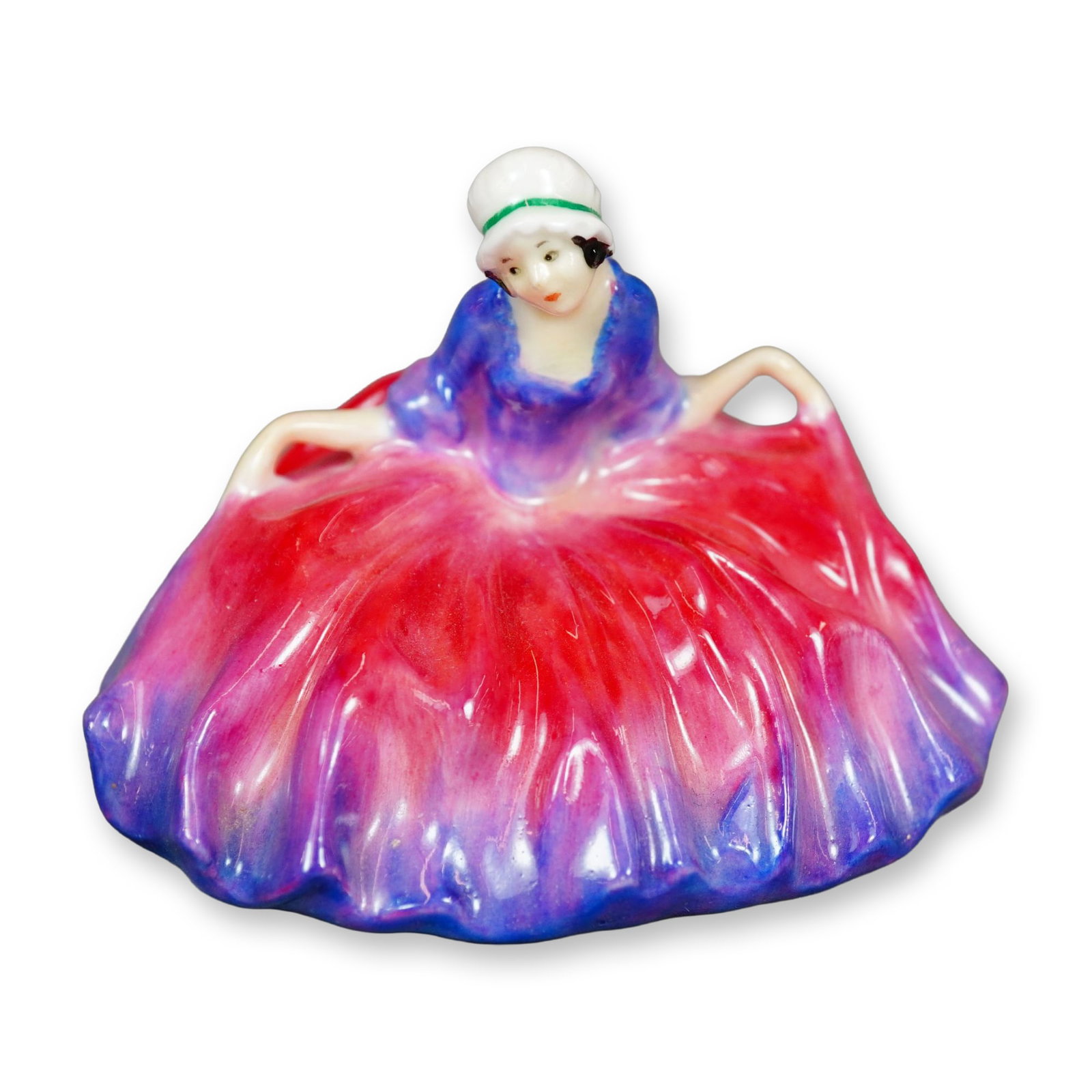 Royal Doulton Figurine, Polly Peachum: Character from "The Beggar's Opera", the figure depicts a young woman curtsying. She is shown wearing in a pink and purple gown. Royal Doulton backstamp. Dimensions: 3"L x 2.5"W x 2.25"H Manufacturer 