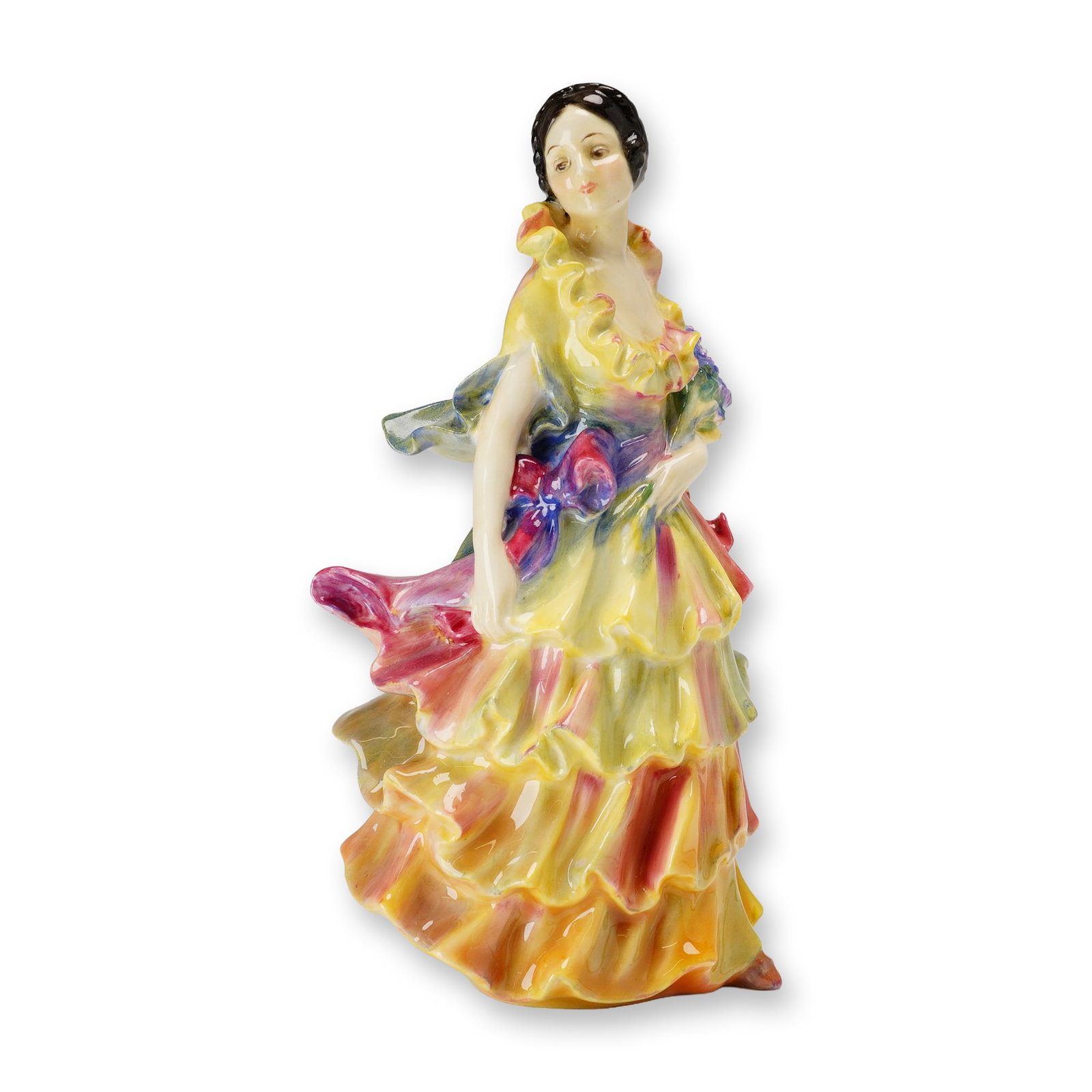 Royal Doulton Porcelain Figurine, Pamela HN1469: Designed by Leslie Harradine. The standing figure is modeled in a multi-tiered ruffled dress with hand-painted color accents of yellow, pink, orange, and purple, holding a small bouquet of flowers. Ba