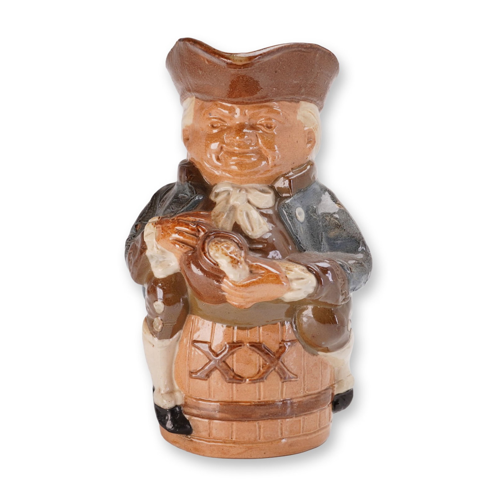 Royal Doulton Lambeth Simeon Toby XX Jug: Toby jug in glazed stoneware, depicting the Simeon character seated on a barrel incised with XX. The figure is modeled in 18th-century attire with a blue frock coat and brown tricorn hat, shown holdin