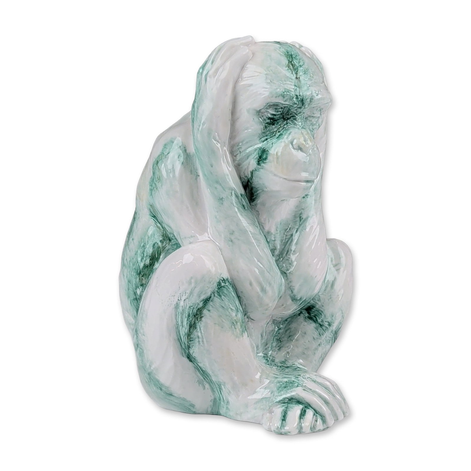 Royal Doulton Prototype Chinese Jade Porcelain Monkey Figurine: Seated monkey featured in a white base glaze with green marbling following the body contours. The monkey modeled with hands pressed against its ears. The underside bears the Royal Doulton backstamp. D