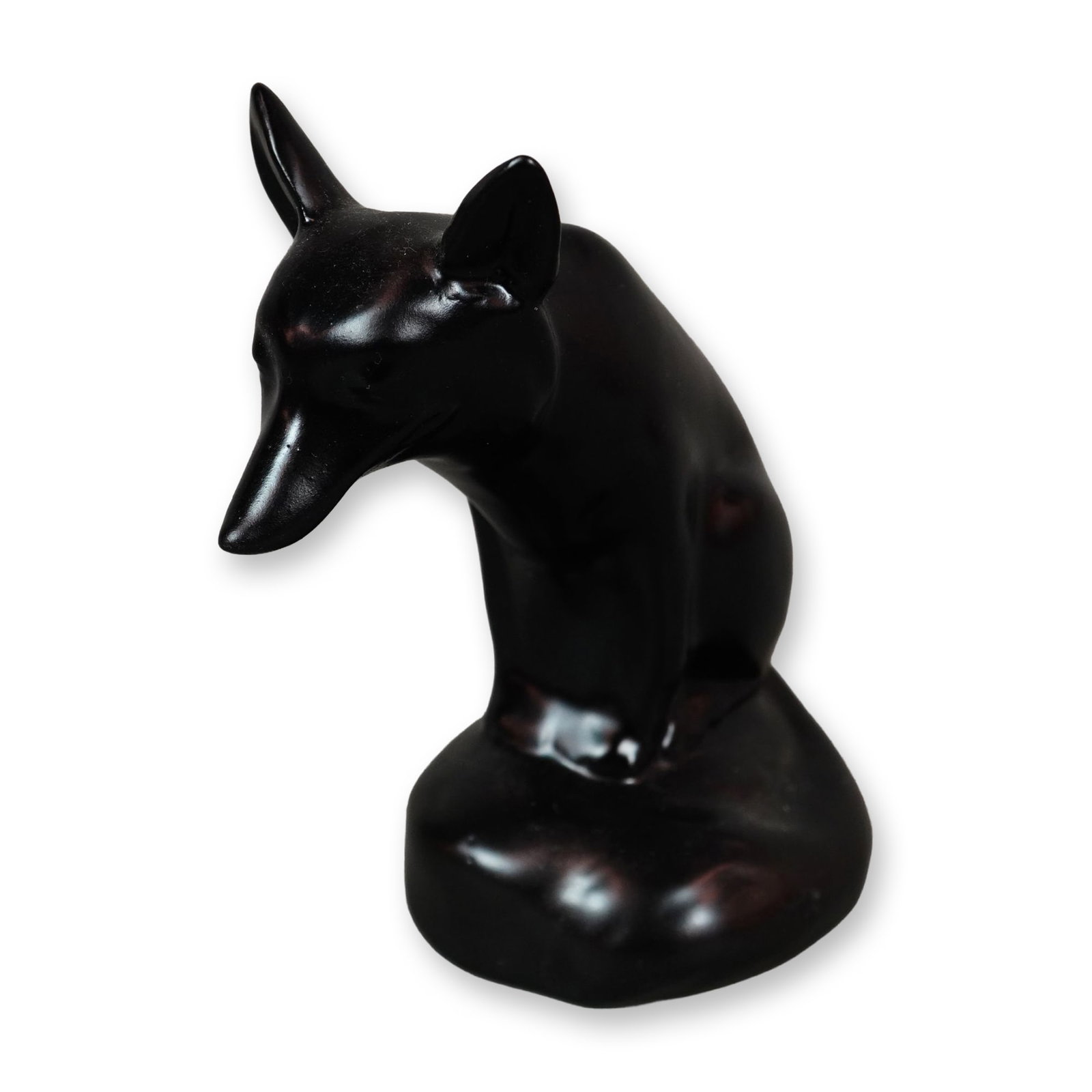 Rare Royal Doulton Black Experimental Glaze Figurine, Fox Seated: A finely modeled porcelain figure of a seated fox resting on a rock, its tail gracefully curled around to the front. The piece is finished in a smooth black satin glaze, with the underside left unglaz