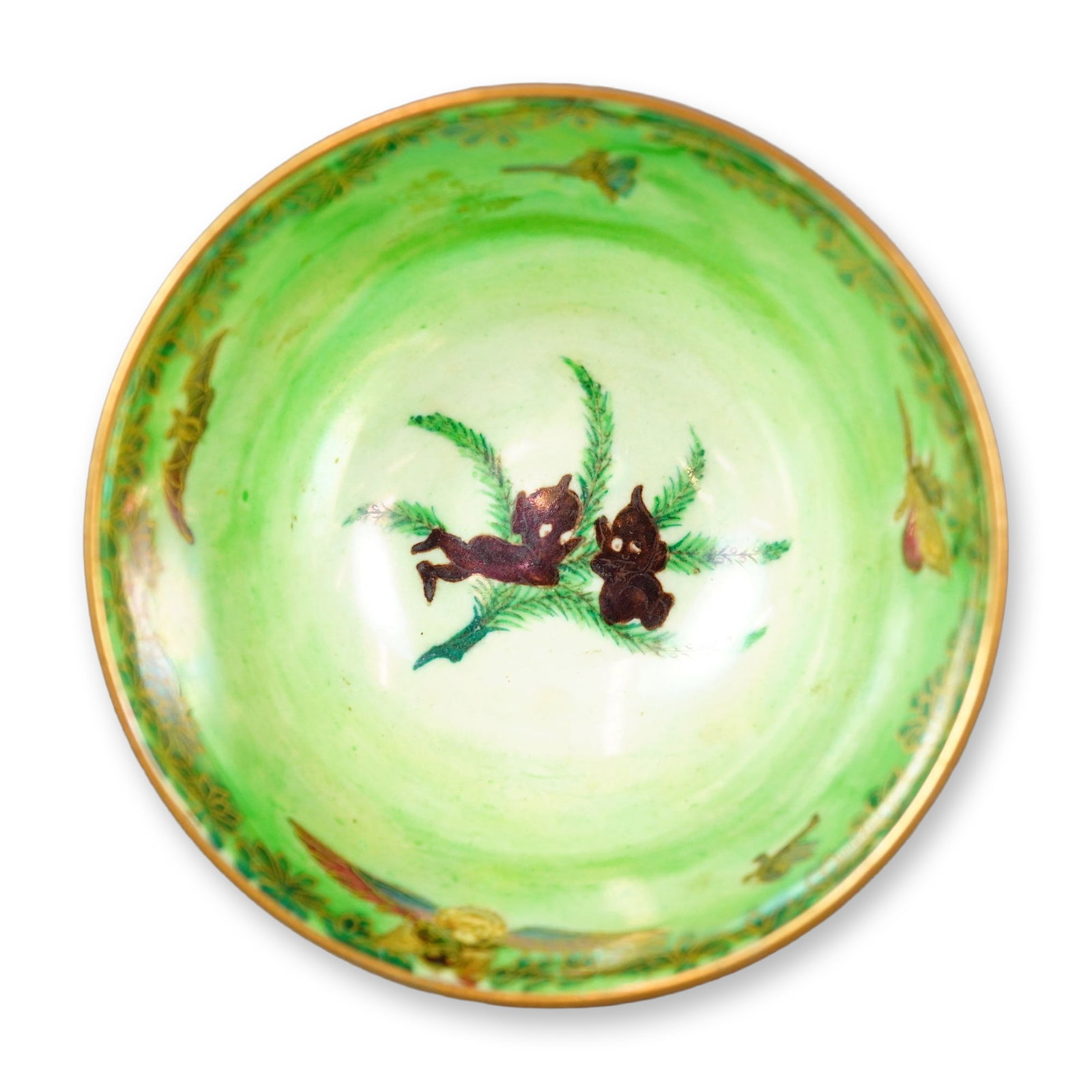 Wedgwood Flame Fairyland Lustre Bowl, Leapfrogging Elves Z5360: Designed by Daisy Makeig-Jones. The exterior is decorated with the "Leapfrogging Elves" pattern, depicting an orange-crimson starry sky above green ground, with winged elven figures rendered in brown.