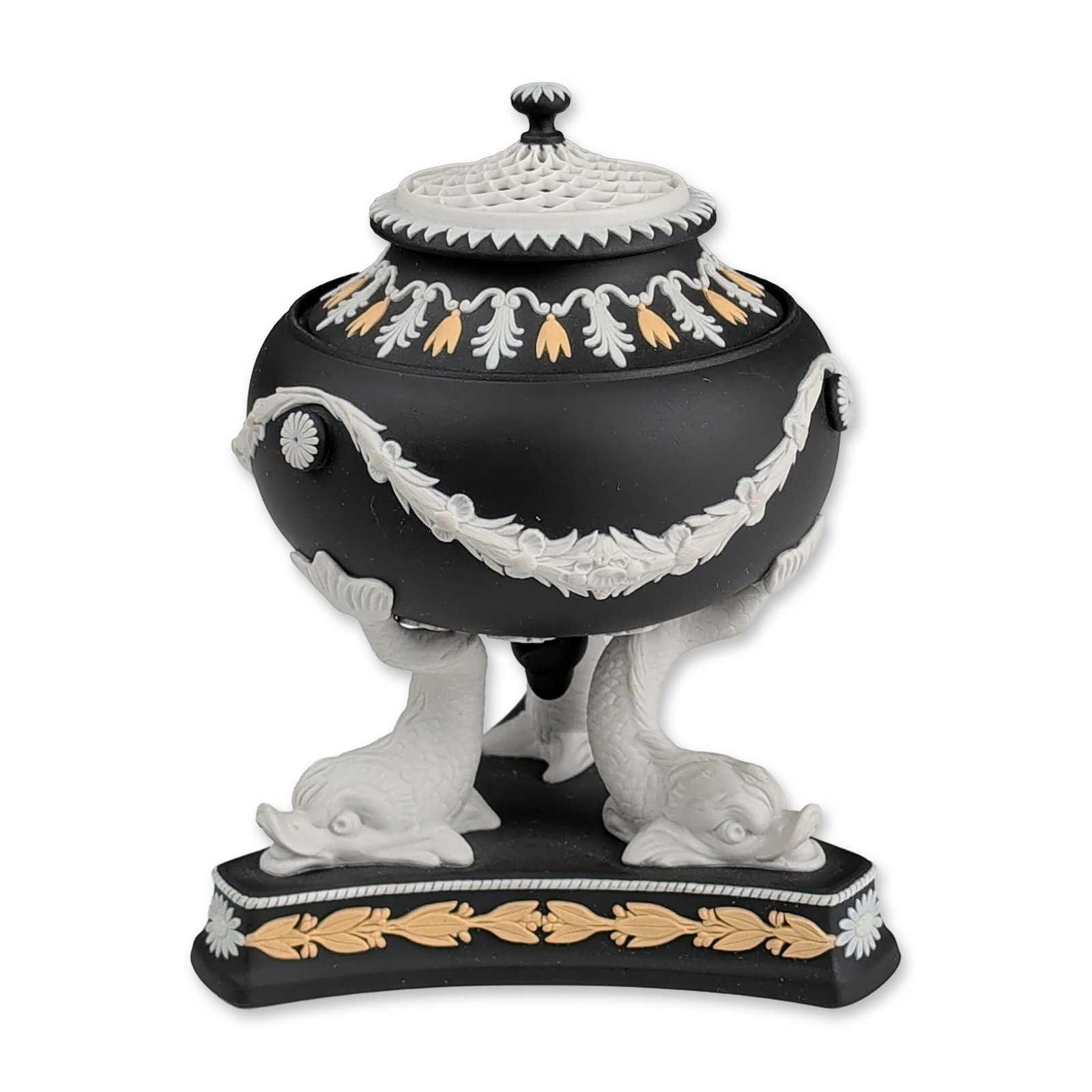 Wedgwood Tri-Color Jasperware Dolphin Lidded Tripod Potpourri Urn: Featuring a globular vessel supported by three white jasper dolphins on a triangular plinth base. The vessel is decorated with sprigged white jasper floral garlands and anthemion borders, while the ba