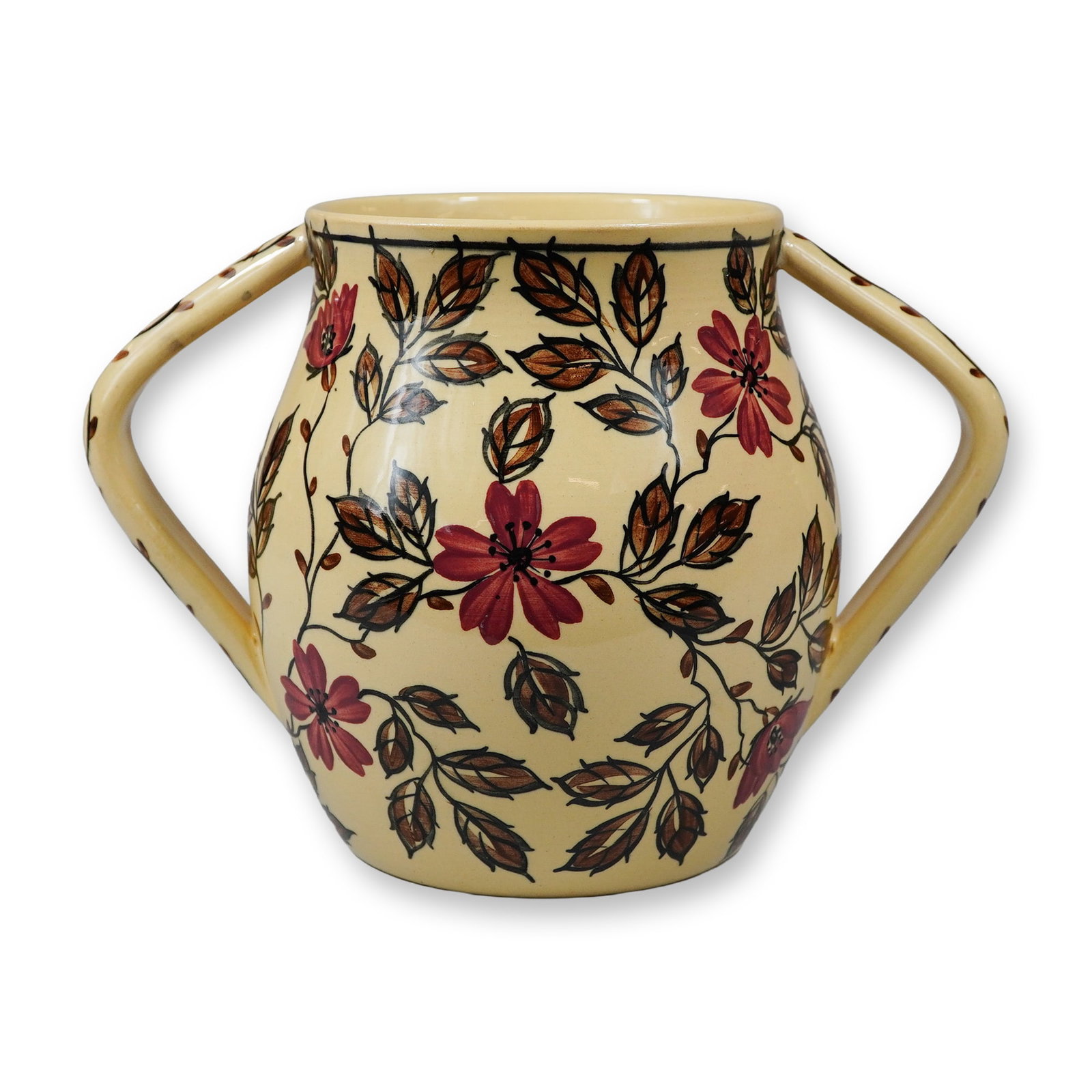 A Wedgwood Caneware Two-Handled Jug Decorated by Stella Star Wedgwood, dated 1931: This bulbous Wedgwood caneware jug features a buff-colored earthenware body with two angular handles extending from the rim to the mid-body. The piece is hand-painted with a continuous trailing floral