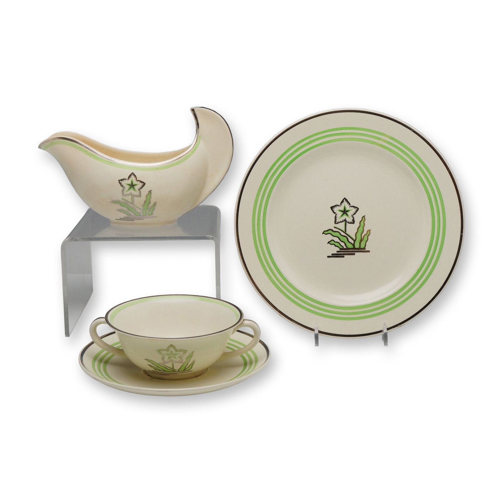 4pc Wedgwood Moonstone Art Deco Ceramic Serving Group: This 4-piece collection of Wedgwood Moonstone earthenware features an Art Deco pattern, characterized by stylized floral motifs and modernist forms. The group includes a sauce boat with a distinctive