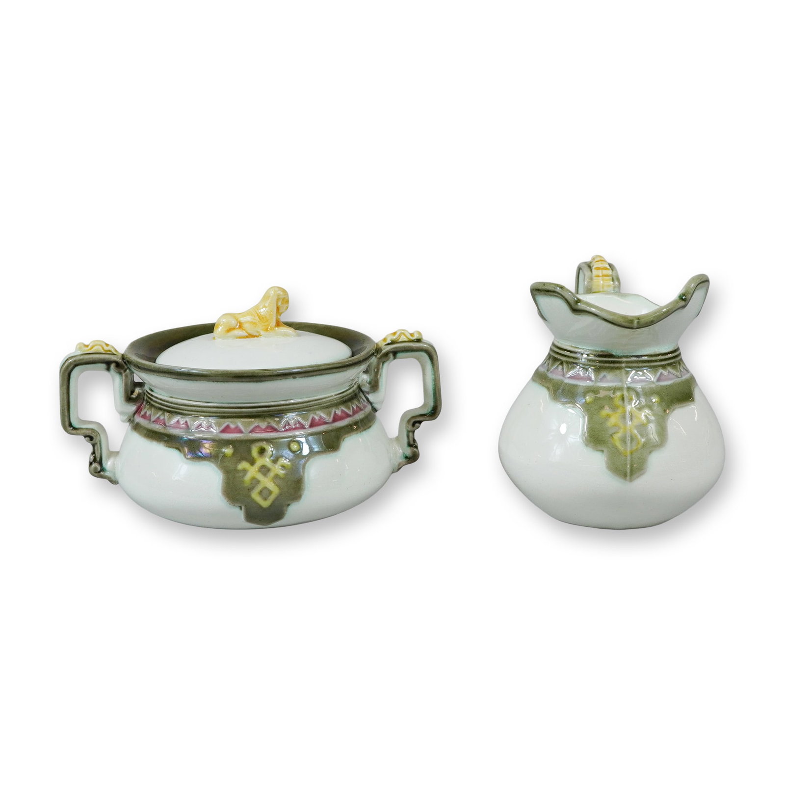 2pc Wedgwood Porcelain Sugar Bowl and Creamer: This set comprises two pieces of fine white porcelain: a lidded sugar bowl and a creamer, produced Wedgwood and dating to the 20th century. The sugar bowl features a bulbous body with two stylized ang
