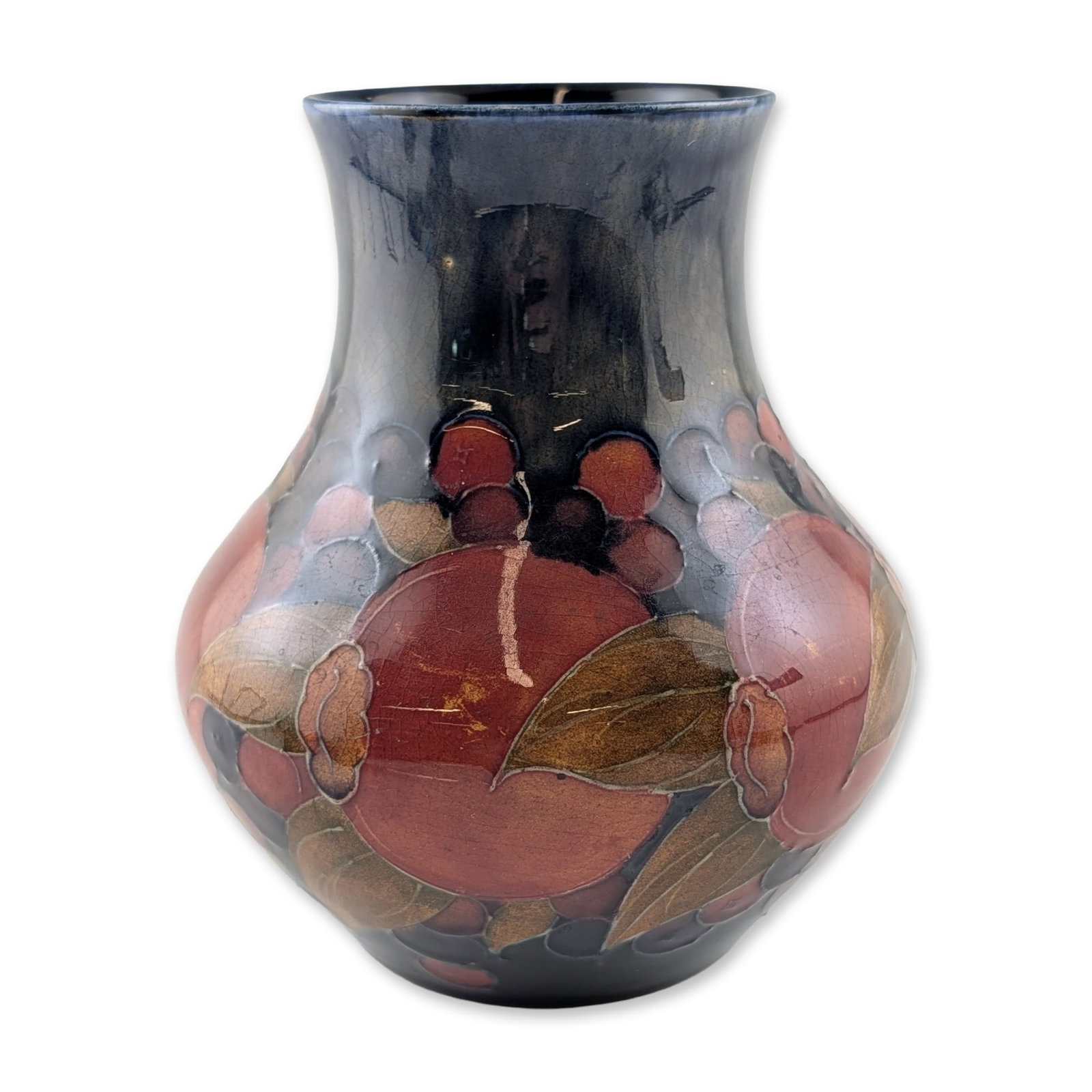 William Moorcroft Pomegranate Pattern Pottery Vase: William Moorcroft pottery vase in the Pomegranate pattern, featuring tubelined and hand-painted pomegranate fruits, berries, and foliage against a dark cobalt blue ground. The design utilizes a palett