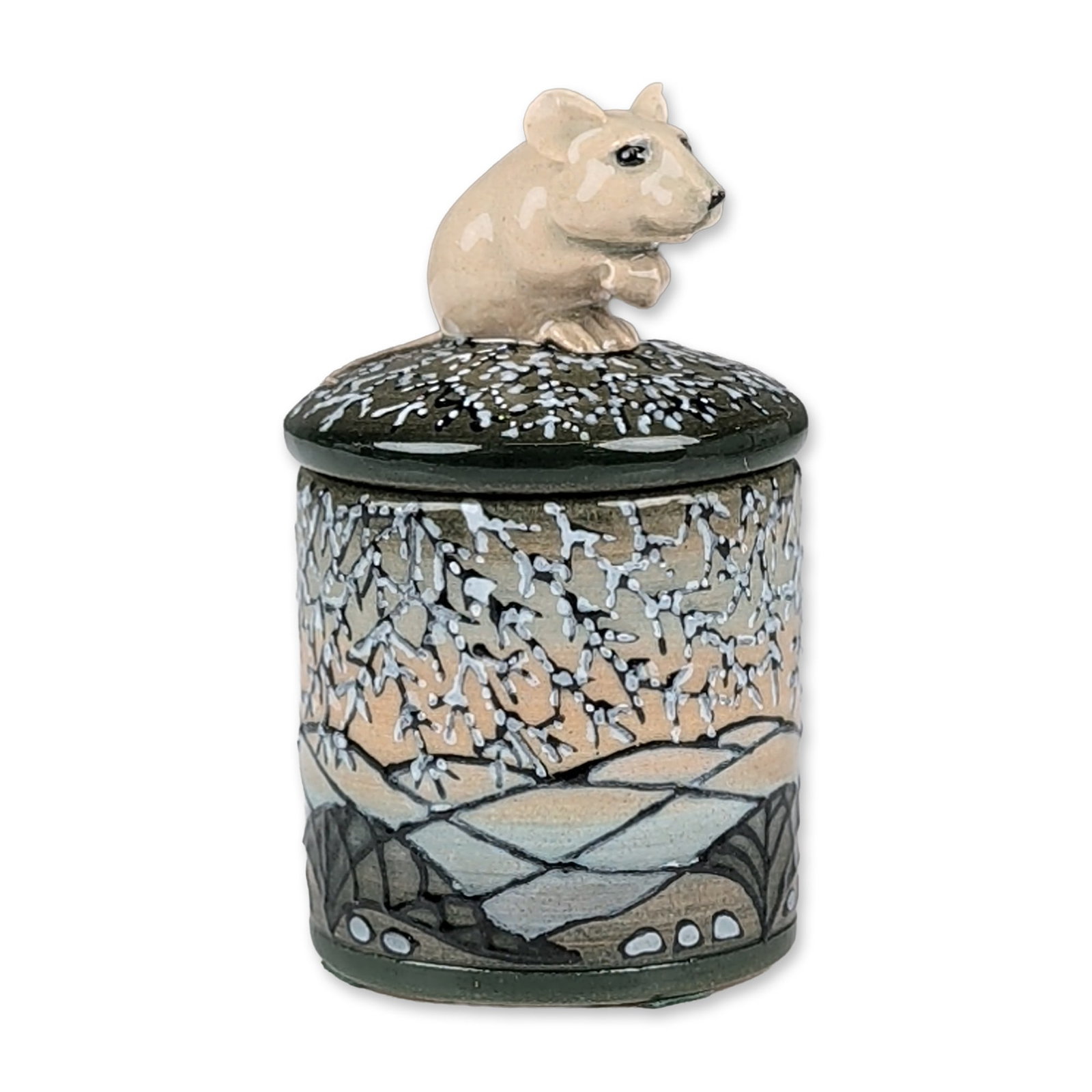 Dennis Chinaworks by Sally Tuffin Miniature Mouse Lidded Box: Featuring a hand-painted winter landscape. The cylindrical body depicts snow-laden branches against a gradient sky transitioning from peach to grey-blue, accented with stylized rock formations. The fi