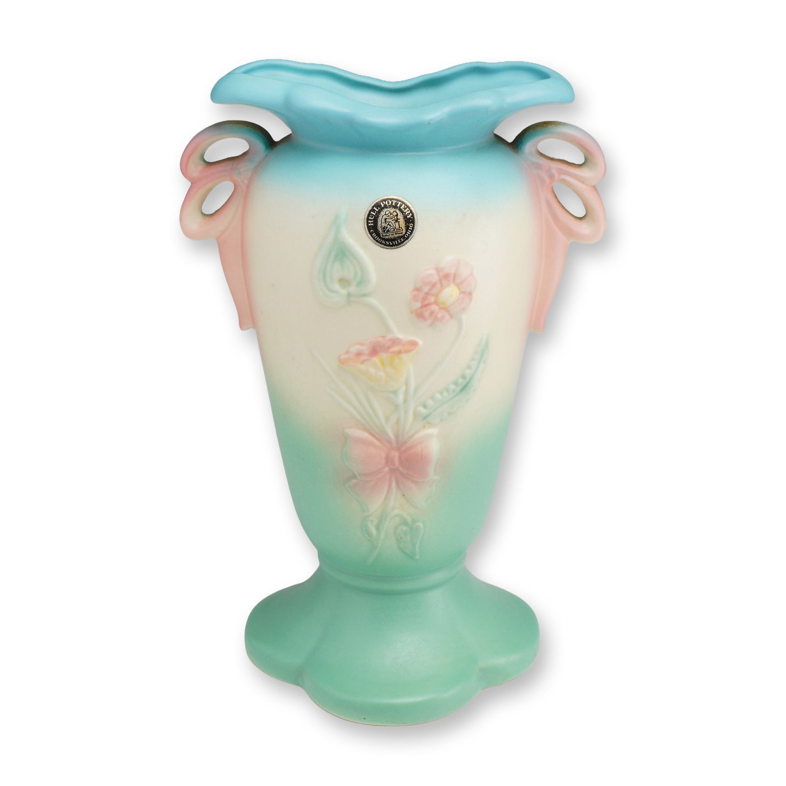 Hull Art Pottery Bow-Knot Footed Vase: An American art pottery vase produced by Hull Pottery of Crooksville, Ohio, in the celebrated Bow-Knot pattern, introduced circa 1940. This ceramic vessel features a molded relief of a floral bouquet 