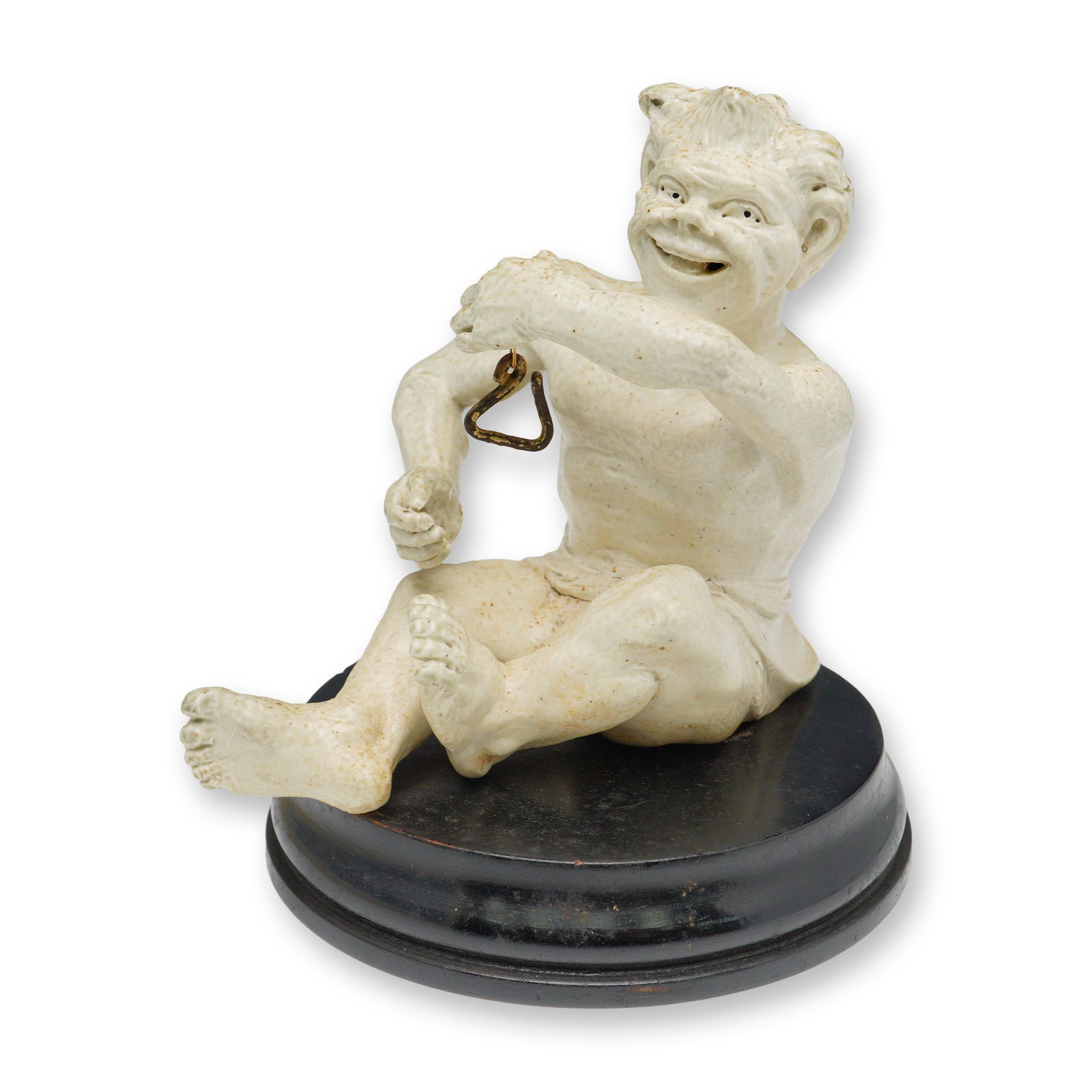 Martin Brothers Stoneware Figurine, Imp Musician - The Triangle Player: Figural sculpture crafted in salt-glazed stoneware by the Martin Brothers pottery workshop, known for their whimsical grotesques and sculptural pottery. This seated imp figure is depicted in motion, w