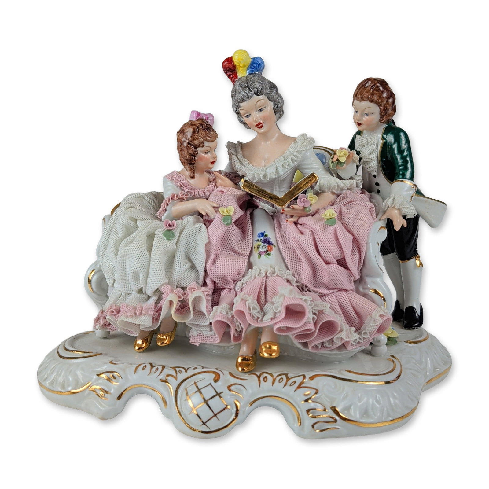Dresden Western Germany Porcelain Lace Figural Group: Dresden, Western Germany. Large figural group in porcelain with applied porcelain lace detailing. The composition depicts an 18th-century scene with a seated woman reading a gilded book, a young girl,