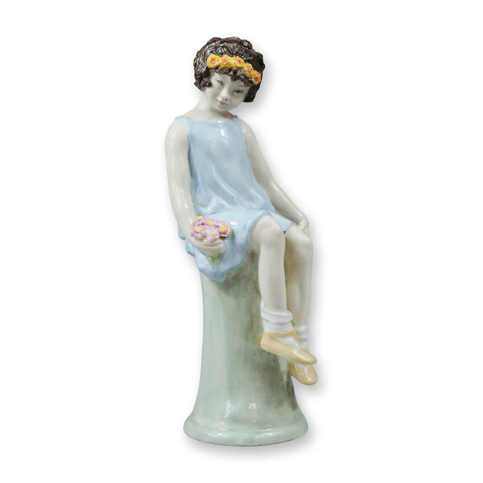 Wedgwood Porcelain Figurine Will o Wisp by Kathleen Goodwin: A Wedgwood porcelain figure titled Will o Wisp, designed and decorated by artist Kathleen Goodwin. The hand-painted glazed figurine depicts a young girl seated atop a mossy green tree stump. She is dr