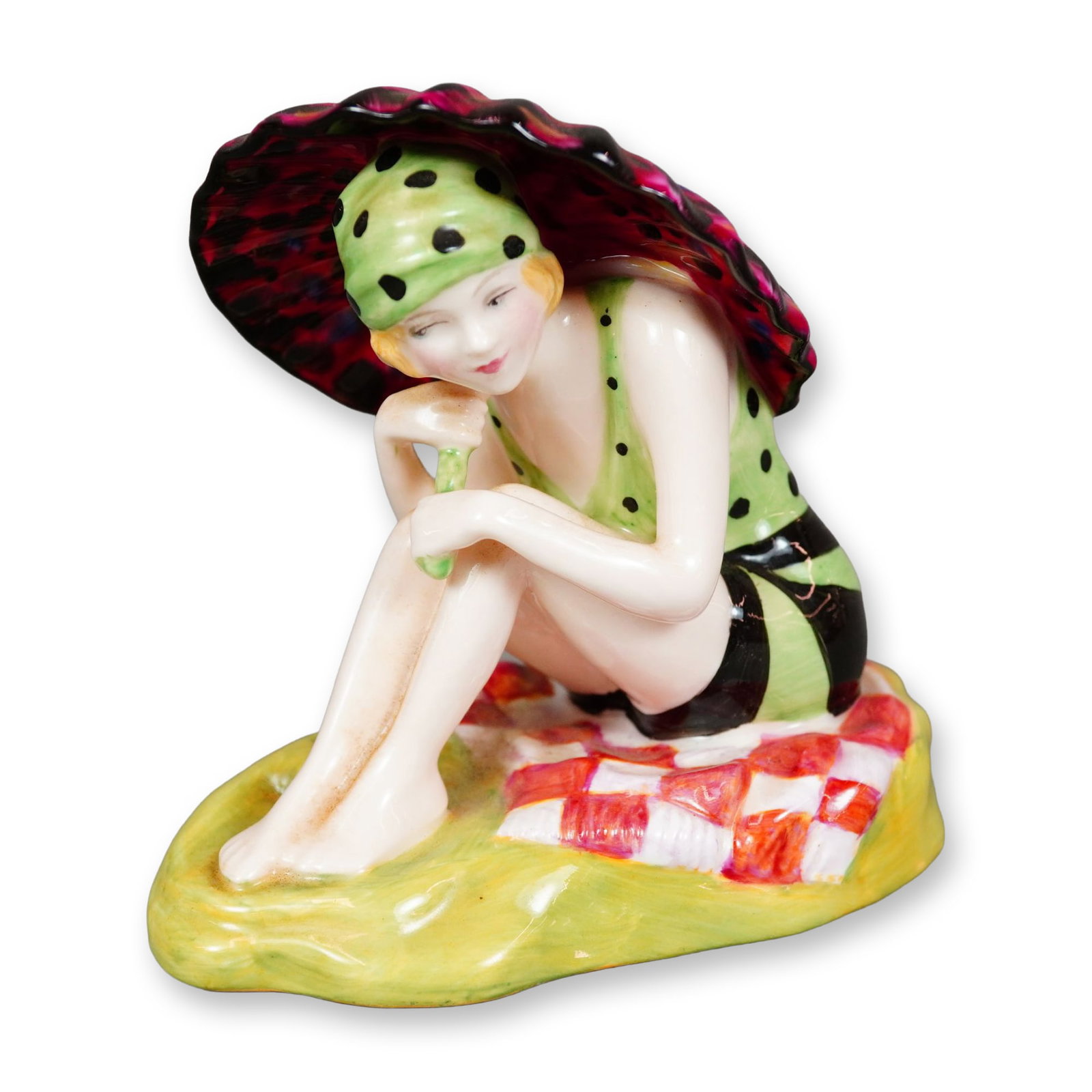 Royal Doulton Archives The Bathers Collection Bone China Figurine, Sunshine Girl HN4245: Hand painted figure of a seated woman in a black and green swimsuit, holding a dark pink umbrella with blue and black accents. This example is from the 2000 Bathers collection modeled by Nada Pedley, 
