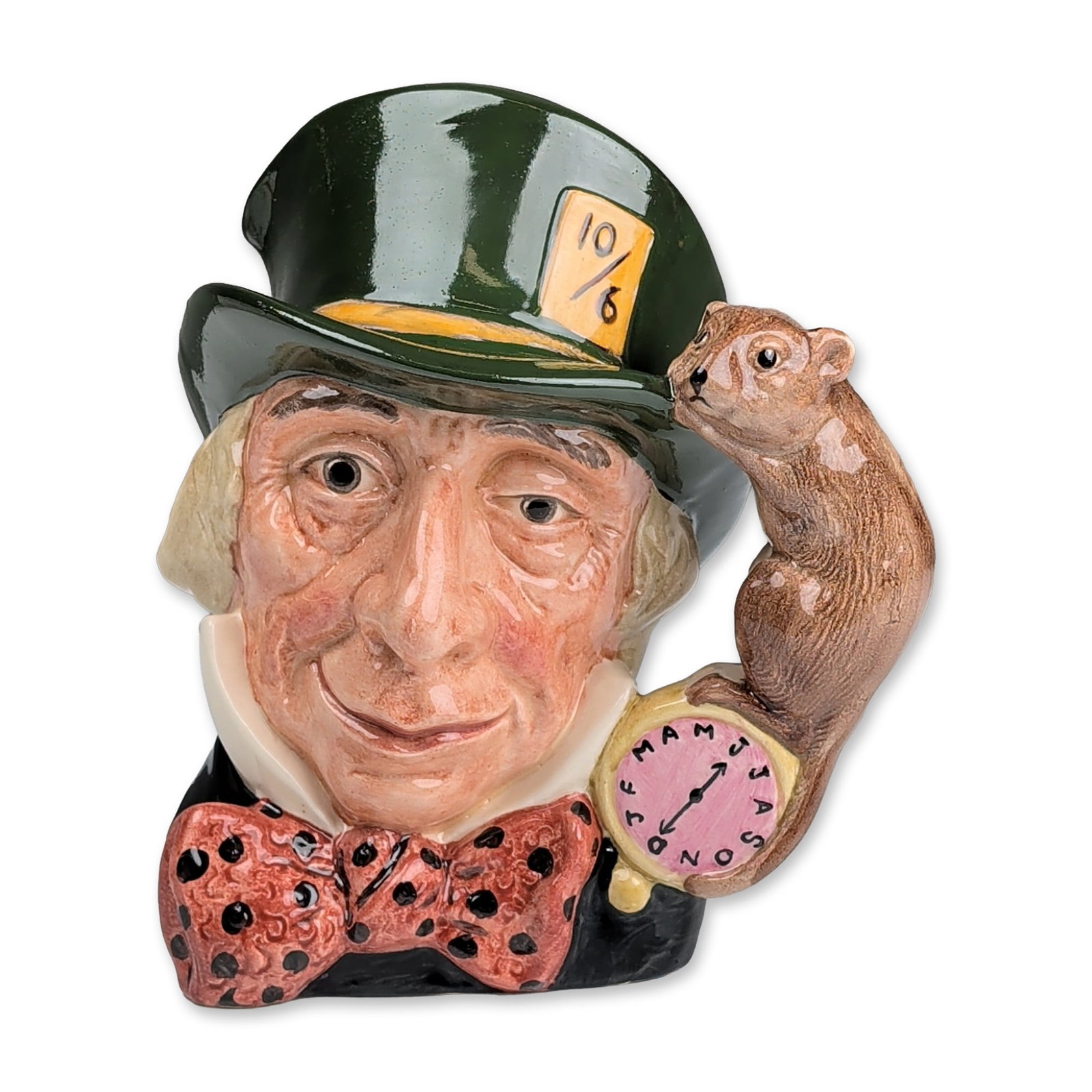 Royal Doulton Colorway Large Character Jug, The Mad Hatter D6598: Depicting the Mad Hatter from Alice in Wonderland. The figure is modeled wearing a dark green top hat with a yellow price tag inscribed 10/6 and a red bow tie with black polka dots. The handle is uniq