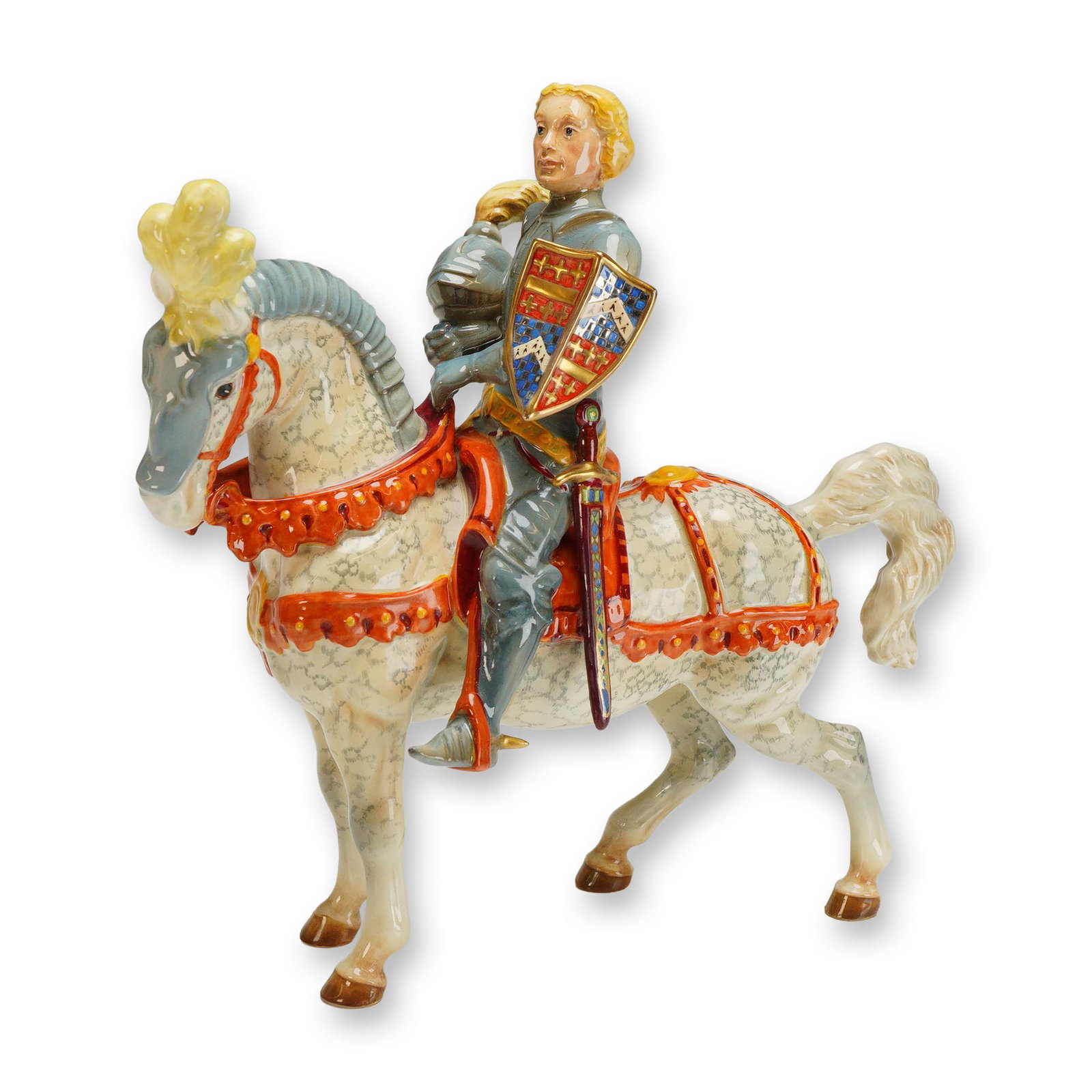 Beswick Porcelain Figurine, The Earl of Warwick: A glazed hand painted figure depicting a knight on horseback. The knight is shown in armor, holding his helmet in one hand, with a red and blue shield featuring gilded detailing beside him. The horse 