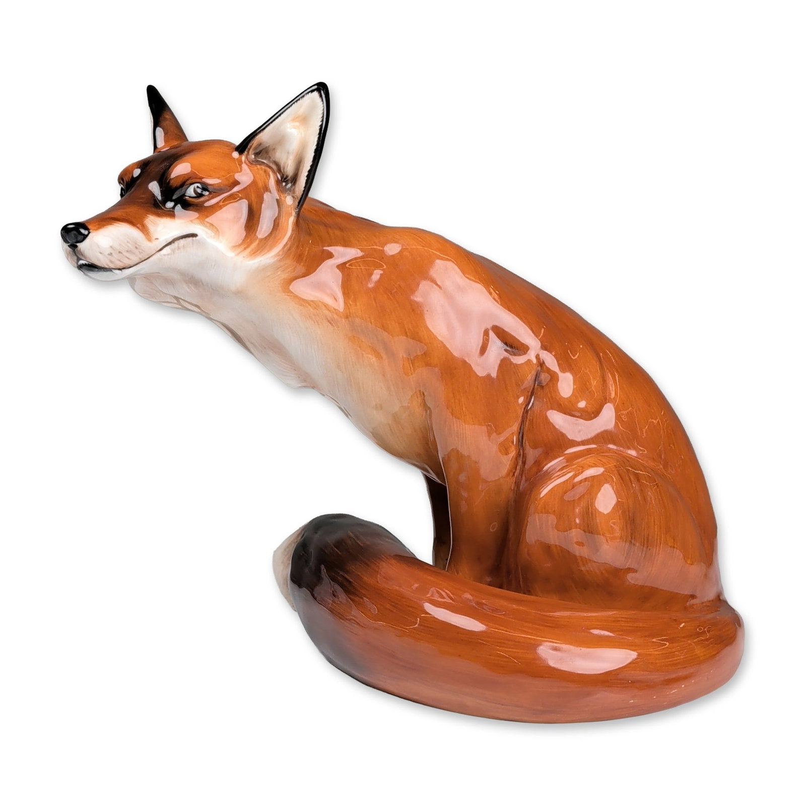 Royal Doulton Bone China Figurine, Fox Seated HN2634: Seated fox figurine in glazed bone china, featuring a naturalistic pose with the head turned and tilted upward. The figure is finished in a high-gloss lead glaze with red-orange and white coloration, 