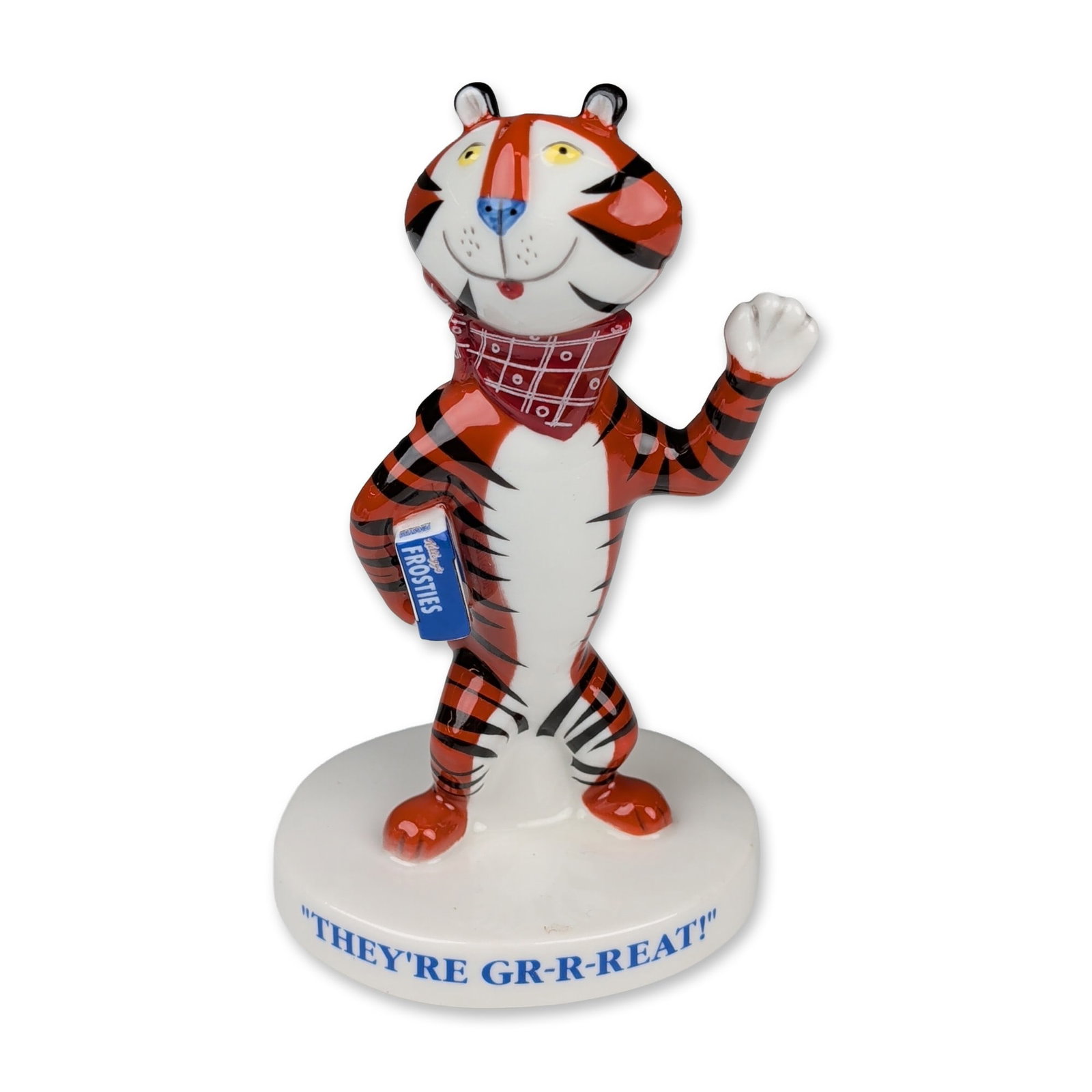 Royal Doulton and Millennium Collectables Limited Porcelain Figurine, Tony the Tiger MCL8: Glazed porcelain advertising figurine of Tony the Tiger modeled by Martyn Alcock. The figure is depicted in a standing pose with one arm raised in greeting and the other holding a box of Kellogg's Fro