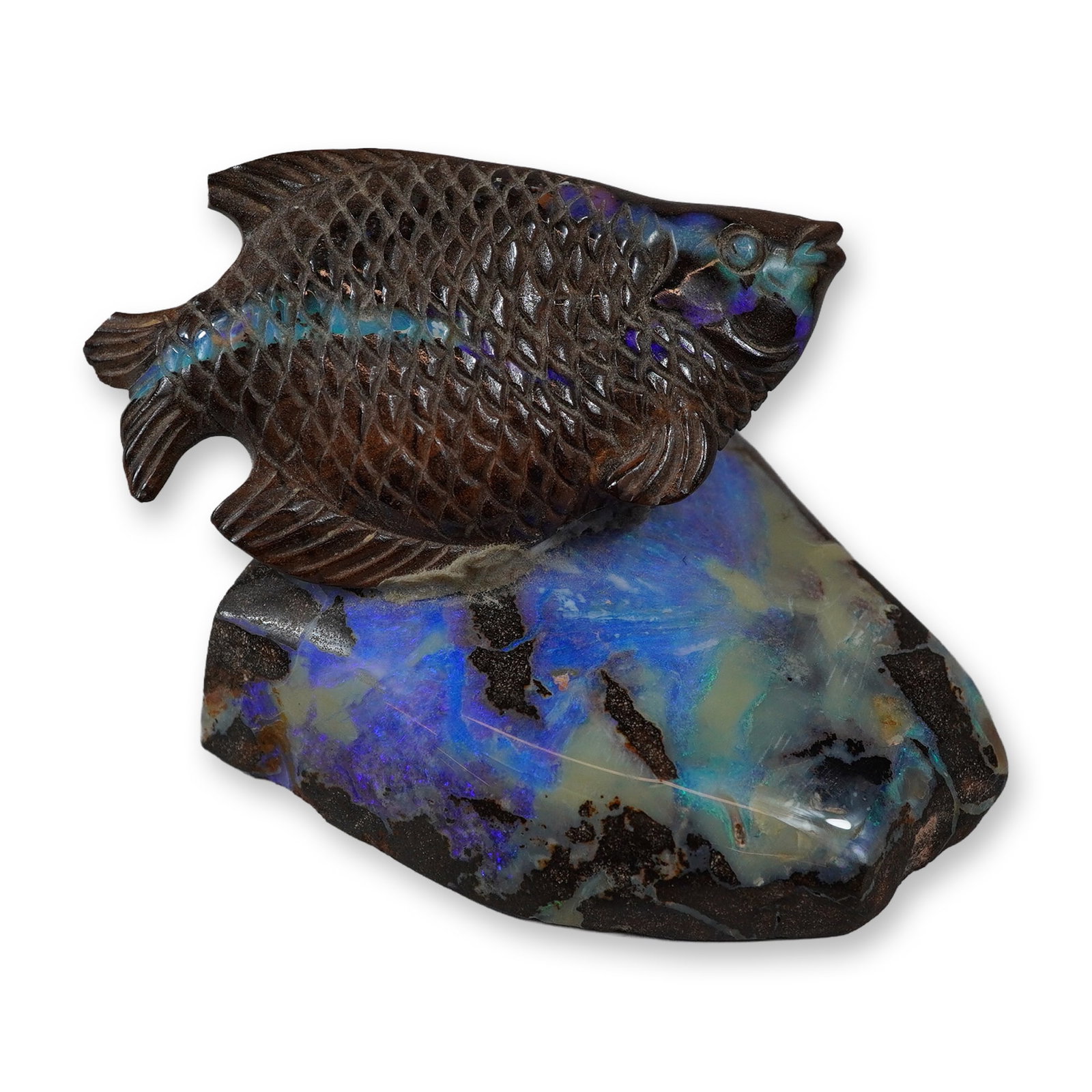 Australian Boulder Opal Fish Figurine on Ironstone Base: This carved figurine of a fish is fashioned from Australian boulder opal, utilizing the natural contrast between the dark brown ironstone matrix and the precious opal. The fish, which resembles a gour