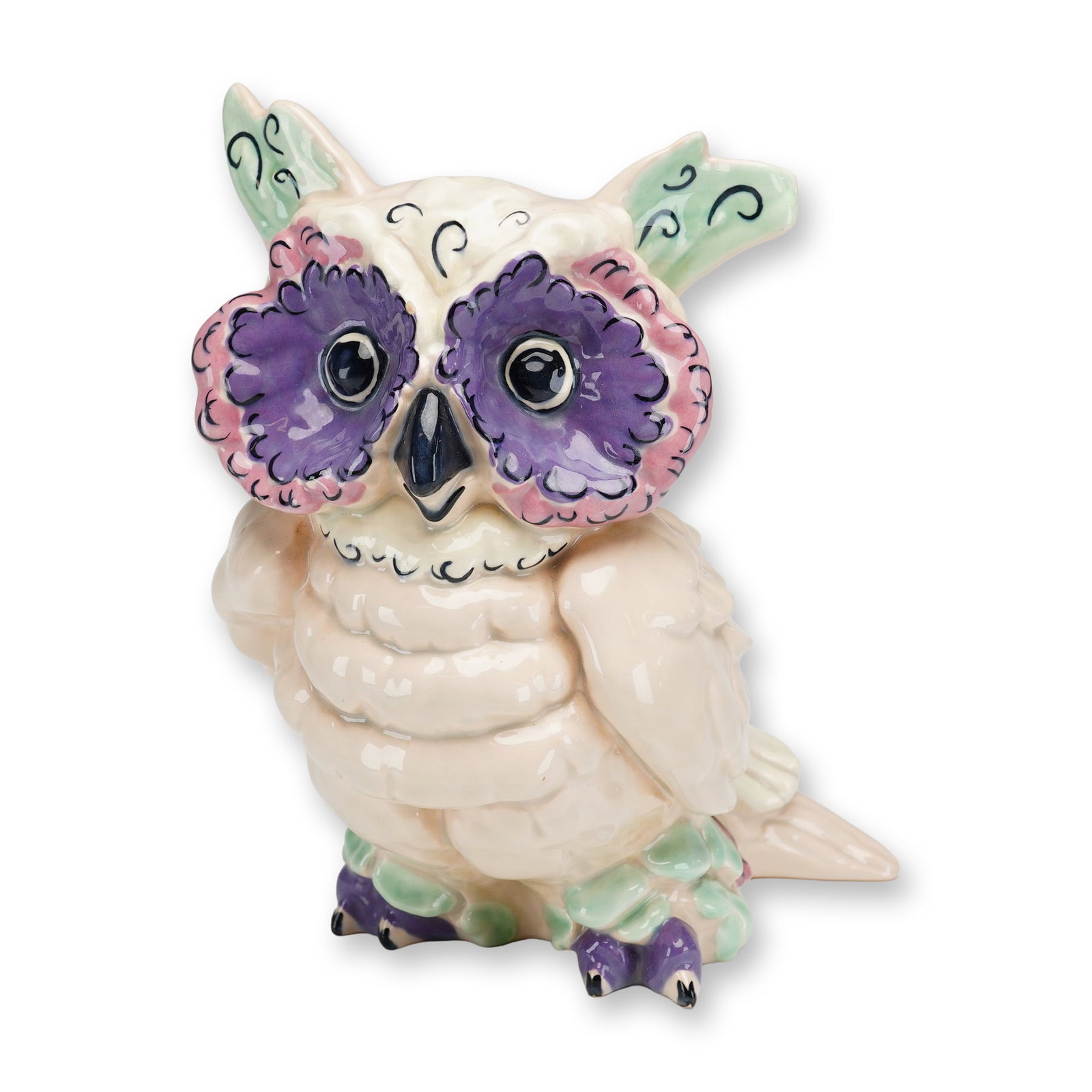 Kay Finch California Pottery Owl Figurine, Hoot: Figurine is crafted from glazed ceramic with a pale pink or cream-colored body and is accented by hand-painted details in shades of purple, green, and black. The piece exhibits textured feather patter
