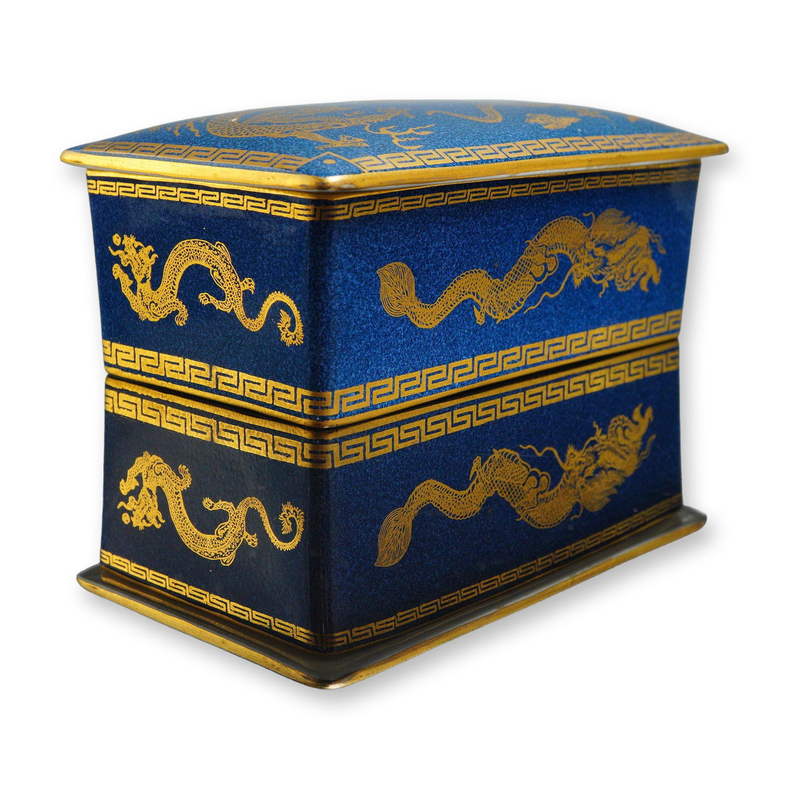 Wedgwood Bleu Souffle Lustre Dragon Lidded Box, Z4616: The lidded box features a powder-blue glazed exterior decorated with gilded dragons surrounding a Sacred Pearl. The rim and lid edges are finished with a Greek key border. The interior is porcelain wh