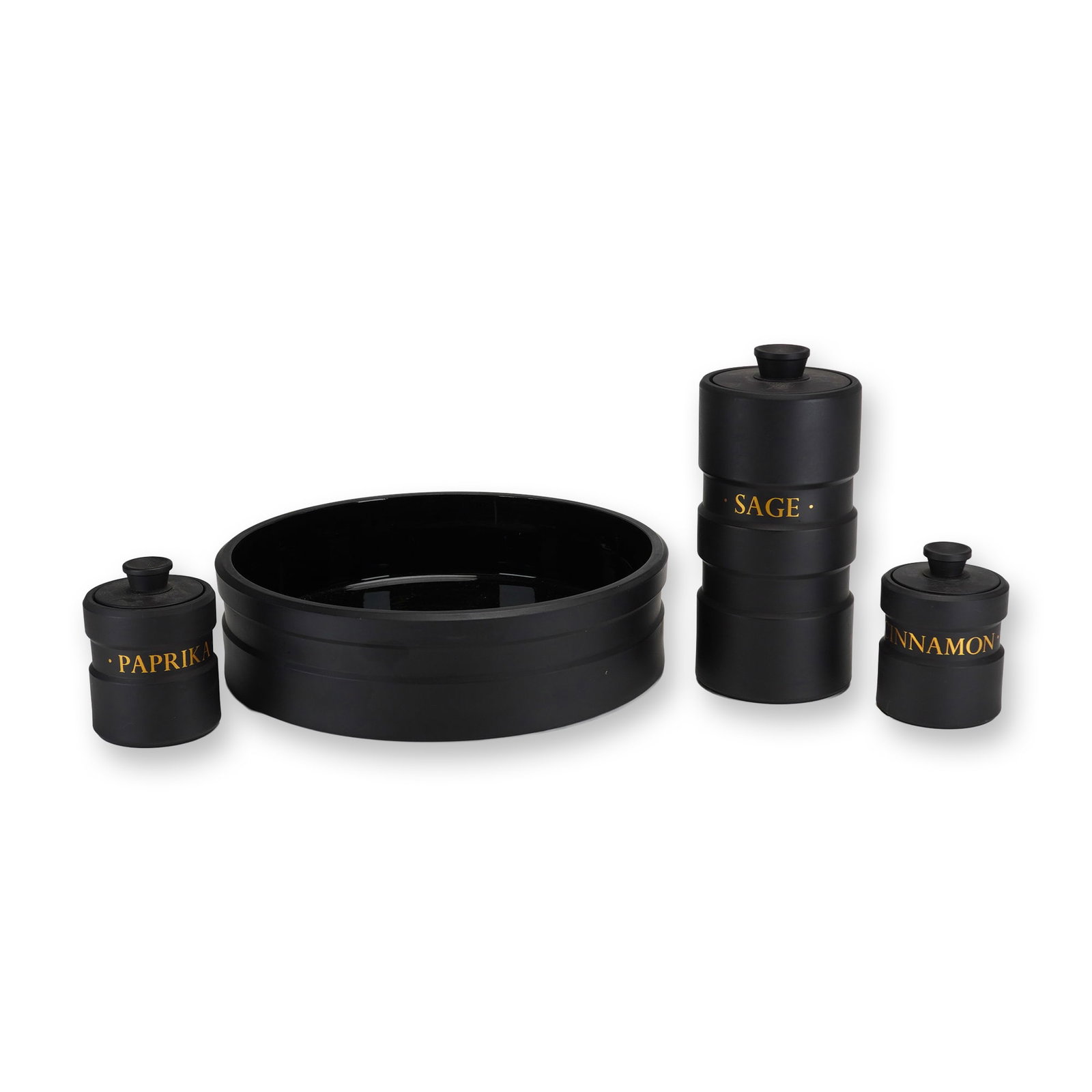 4pc Wedgwood Black Basalt Bowl and Design 63 Spice Jars: This four-piece Wedgwood black basalt stoneware group includes three canisters from the Design 63 line designed by Robert Minkin in 1963 and one wide, shallow round bowl. The canisters are crafted fro