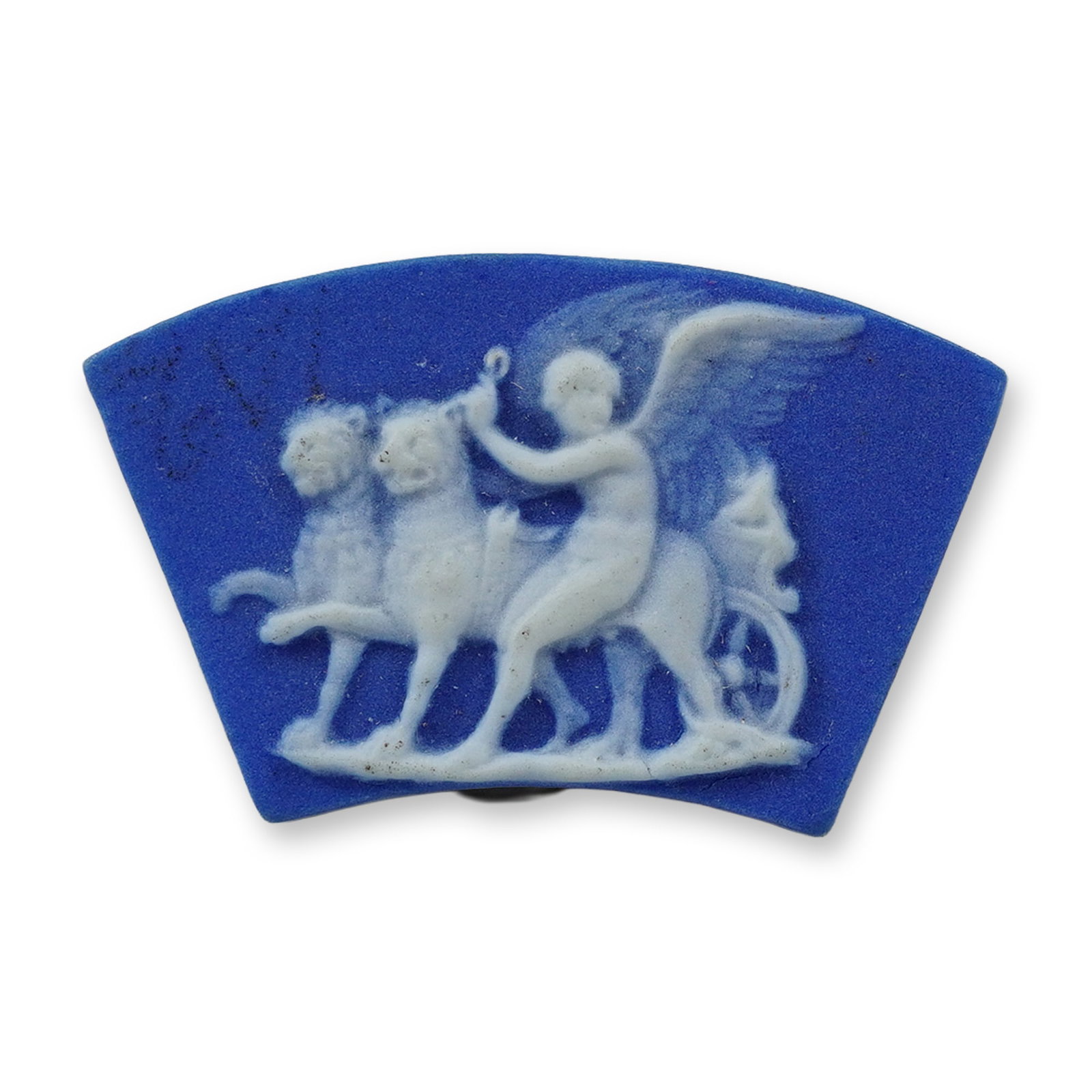 Wedgwood Blue Jasperware Miniature Tile Plaque: A miniature fan-shaped jasperware plaque constructed of blue stoneware with applied white sprigged bas-relief decoration. The scene depicts a winged figure driving a chariot pulled by two lions, a cla