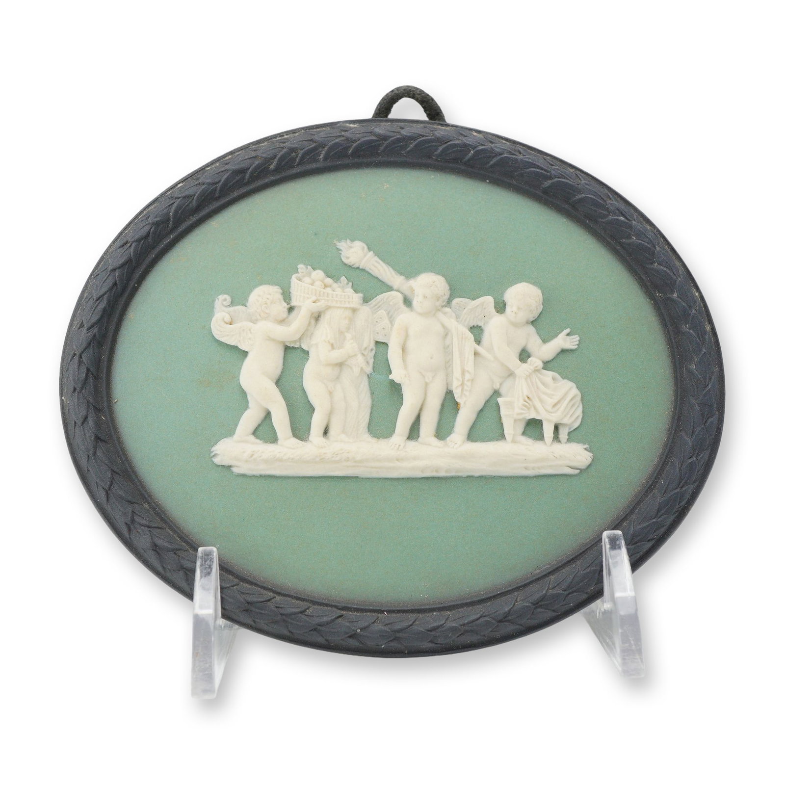 Wedgwood Sage Green Jasperware Plaque The Marriage of Cupid and Psyche by Albert Bentley: This Wedgwood sage green jasperware oval wall plaque features a neoclassical bas-relief scene titled The Marriage of Cupid and Psyche. The white sprigged decoration, applied using the free hand techni