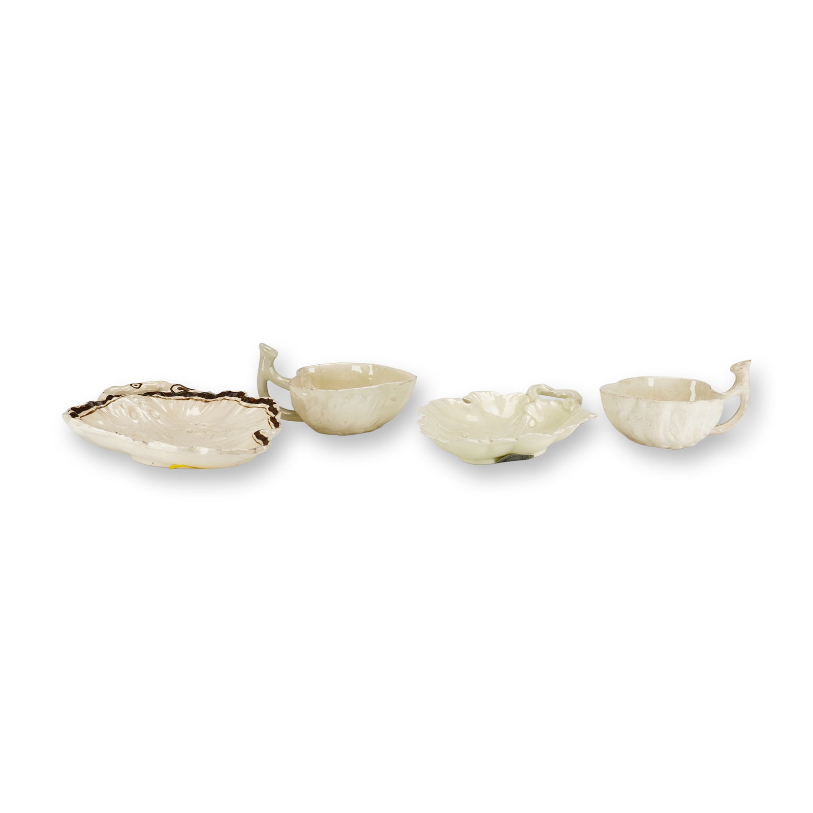 Group of Four Wedgwood Creamware Leaf-Shaped Dishes and Cups: This group consists of four lead-glazed creamware items modeled in botanical leaf forms. The set includes one larger leaf-shaped dish with relief-molded vein details, a scalloped edge, and a twig-form