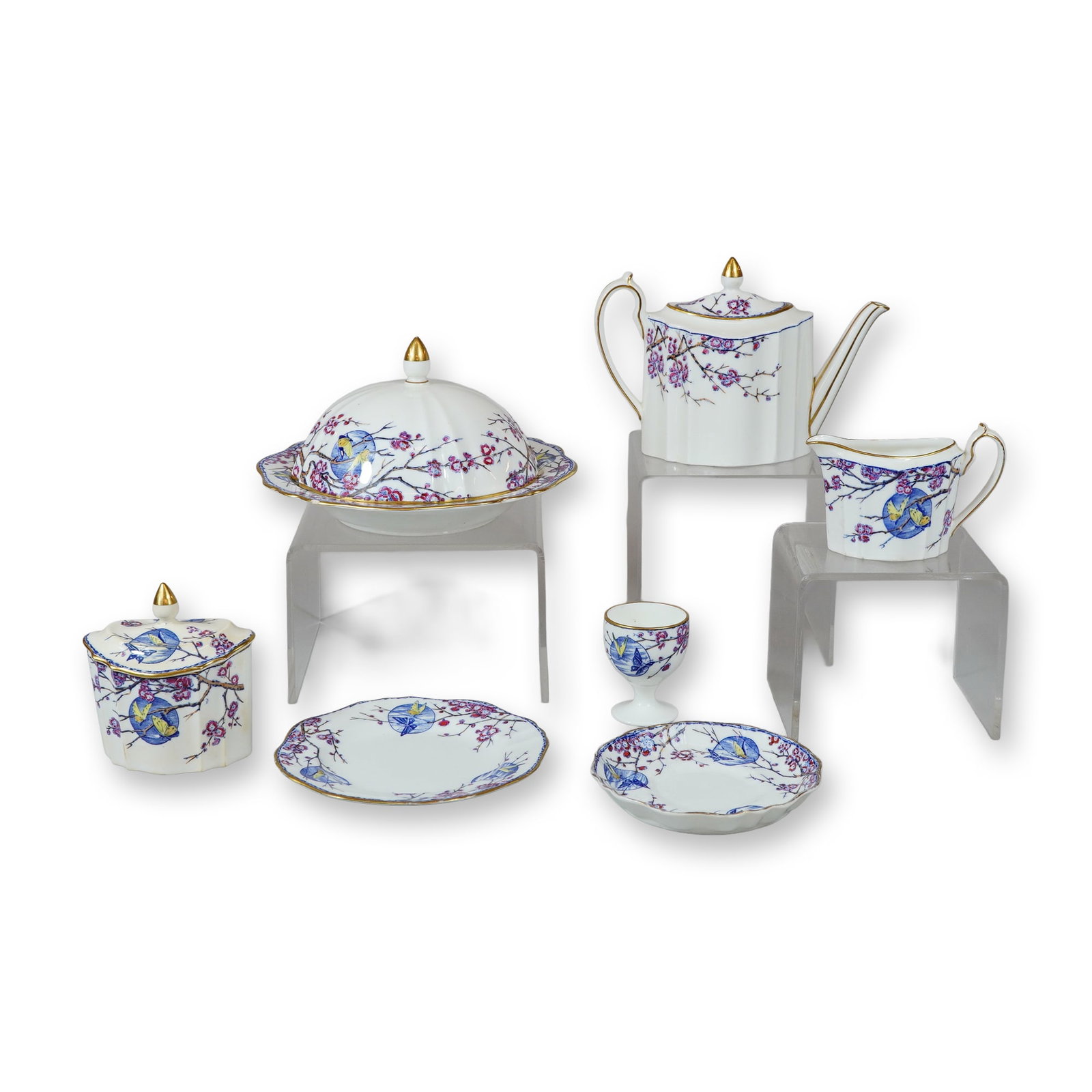 A Set of Wedgwood Bone China Fortune Pattern Tableware: A Wedgwood partial bone china tea and breakfast service in the Fortune pattern, number W926. The set features a white ground decorated with blue and yellow birds among flowering purple branches, a pat