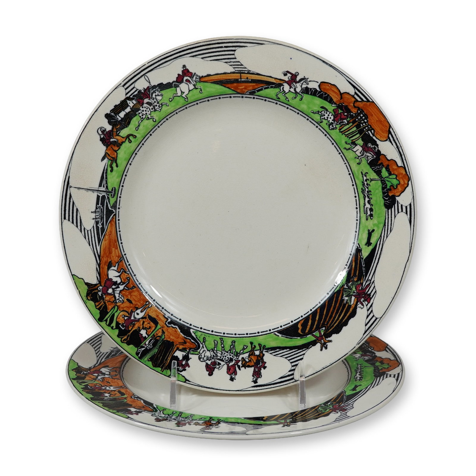 Pair of Wedgwood Etruria by Daisy Makeig-Jones Earthenware Fox Hunting Plates: A pair of English earthenware plates featuring a whimsical fox hunting scene. The decoration, which encircles the rim, depicts stylized hunters in red coats on horseback and hounds in pursuit across a